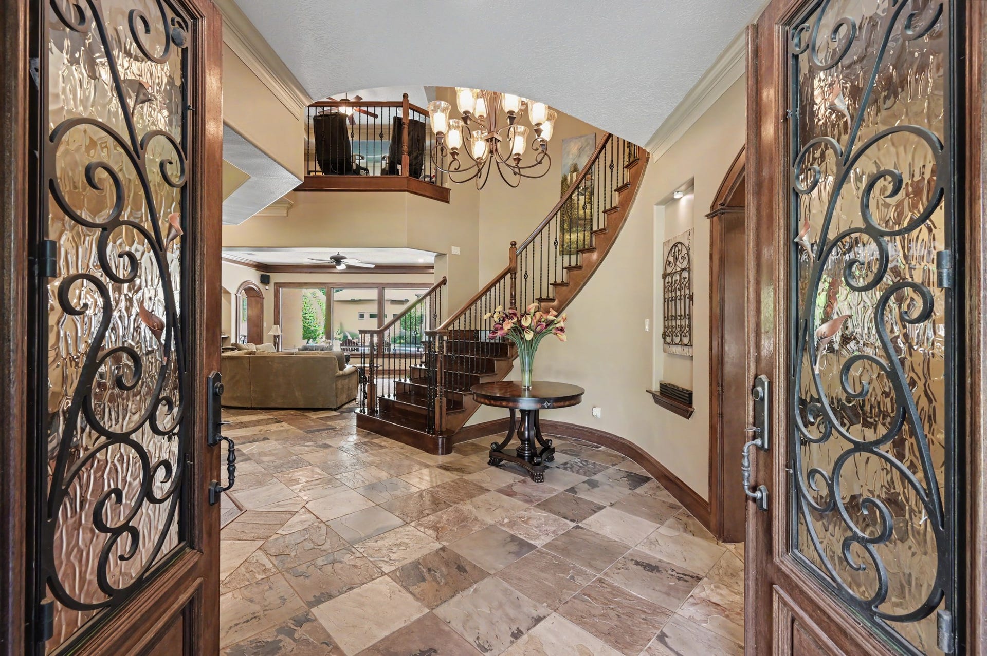 27706 Braydon Court, Spring, TX 77386 Welcoming foyer featuring ornate double doors, a stunning spiral staircase, and a spacious open floor plan with luxurious tile flooring.