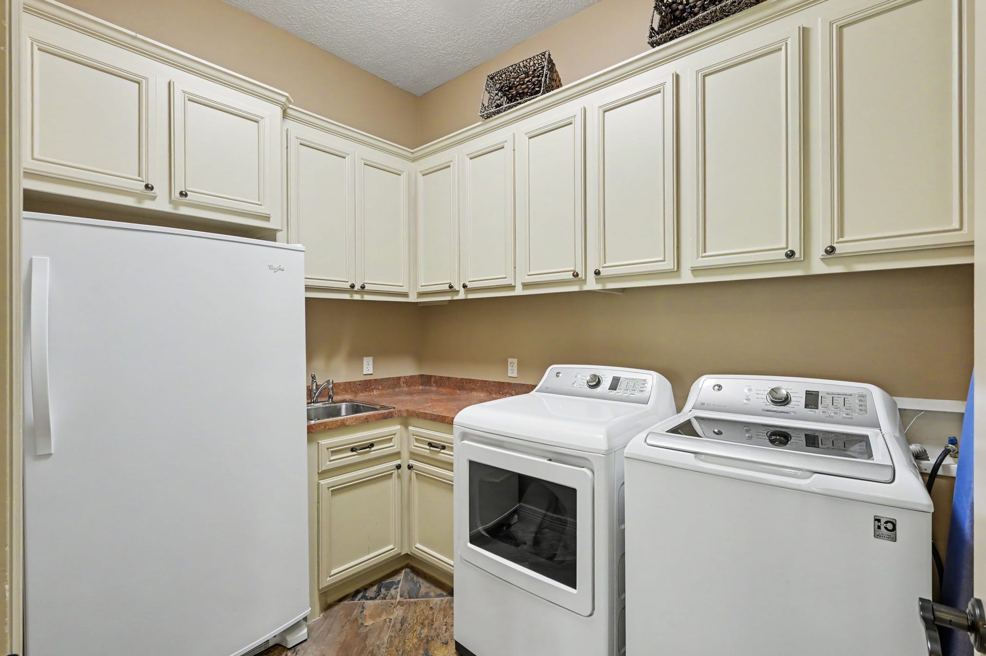 27706 Braydon Court, Spring, TX 77386 Spacious laundry room featuring modern appliances, ample cabinetry for storage, and a convenient utility sink.