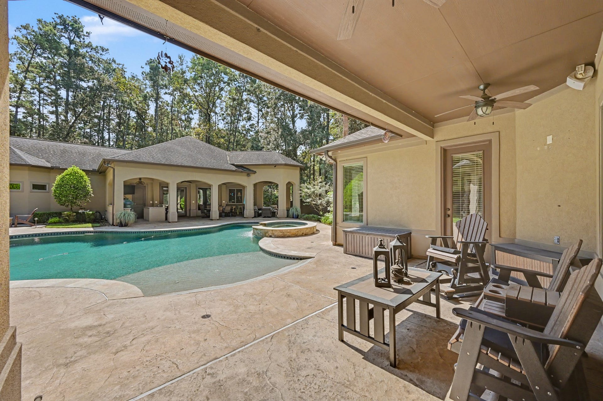 27706 Braydon Court, Spring, TX 77386 Enjoy the serene setting of this backyard oasis featuring a spacious covered patio, inviting pool, and lush greenery, perfect for relaxation and entertainment.