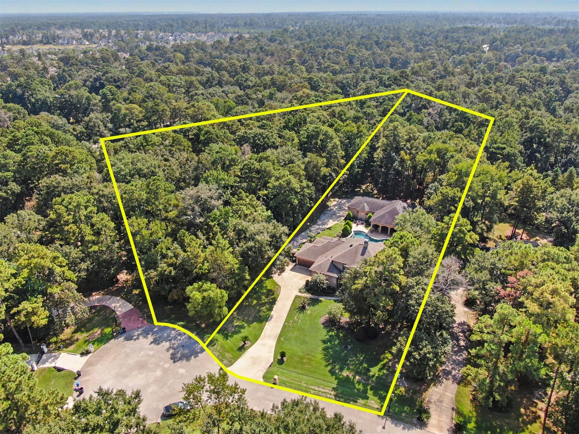 27706 Braydon Court, Spring, TX 77386 Expansive estate nestled in lush greenery, offering privacy and tranquility with a spacious driveway and beautifully landscaped surroundings.