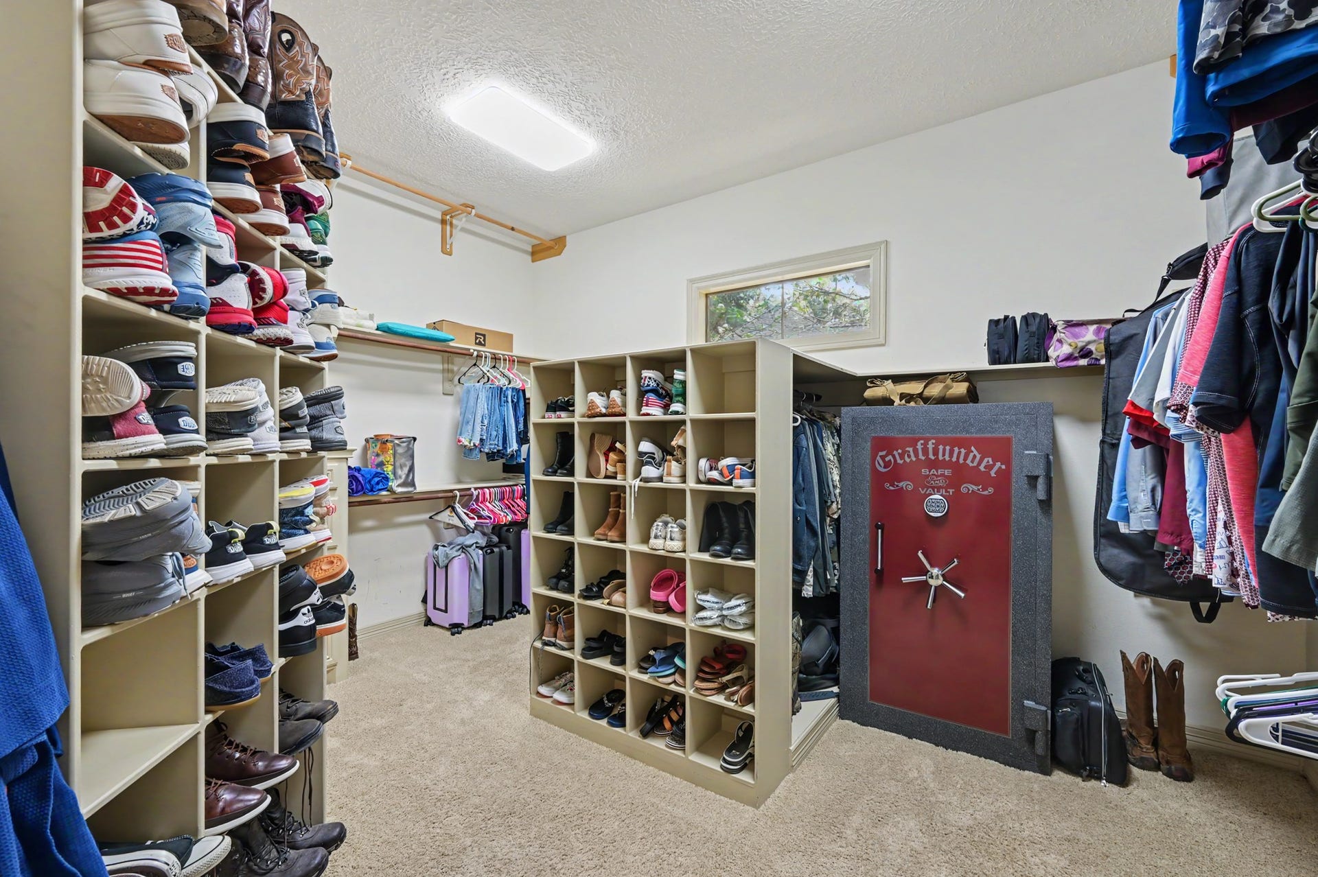 27706 Braydon Court, Spring, TX 77386 Cavernous walk-in closet with abundant built-in shelving for shoes and ample hanging space for clothes.
