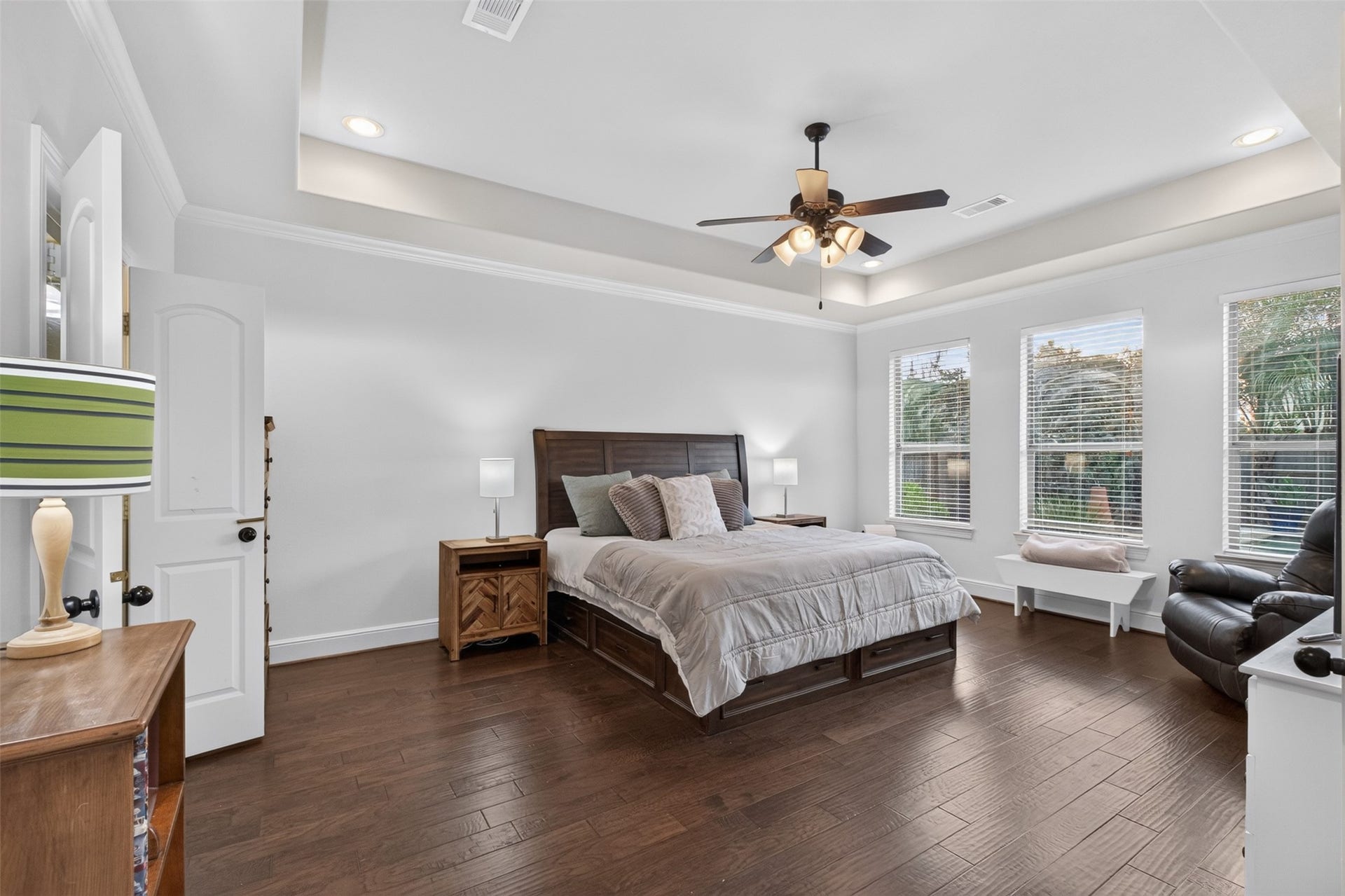 2806 Texas Laurel Drive, Katy, TX 77494 Primary bedroom featuring hardwood floors, tray ceiling, crown molding and a fabulous backyard view