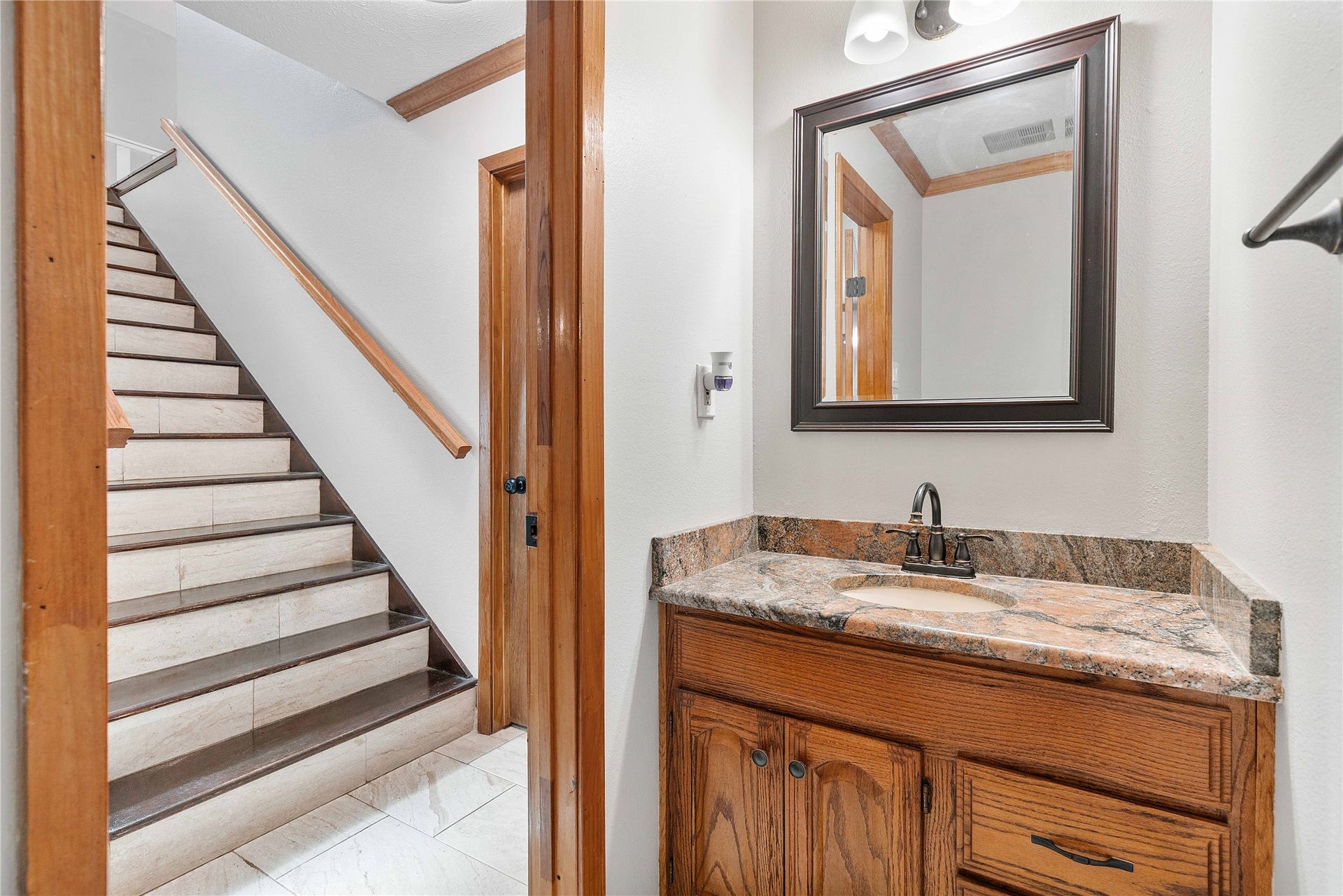 Half bath downstairs next to the stairway