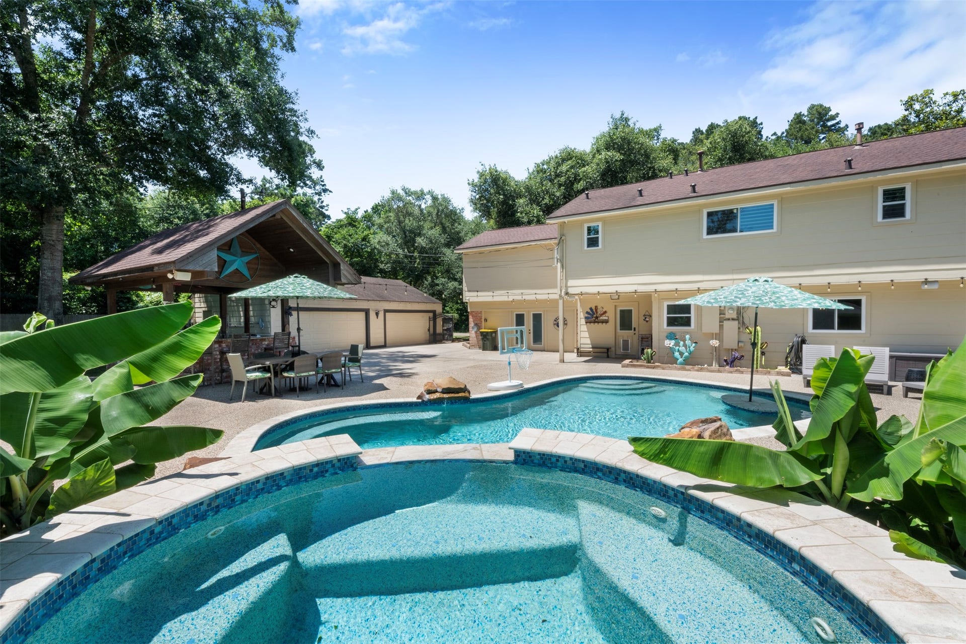109 Riverbrook Drive, Conroe, TX 77385 Pool and jacuzzi. Detached garage -- converted man-cave in back