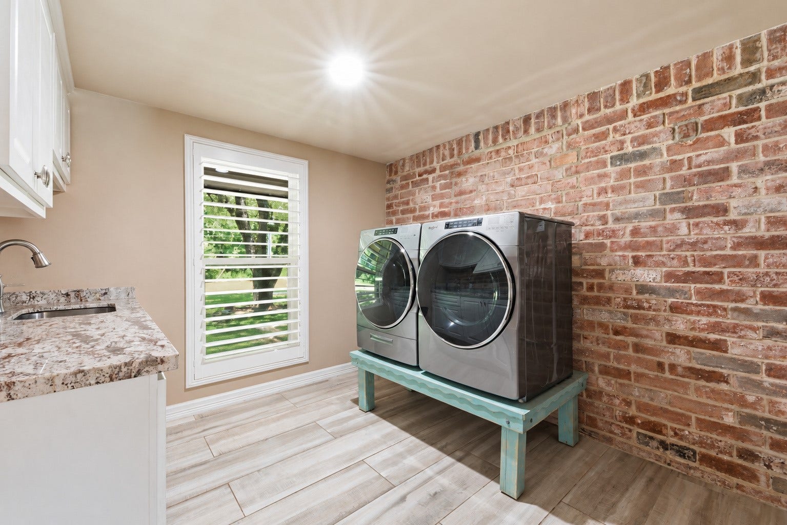 109 Riverbrook Drive, Conroe, TX 77385 Laundry room with brick accent wall