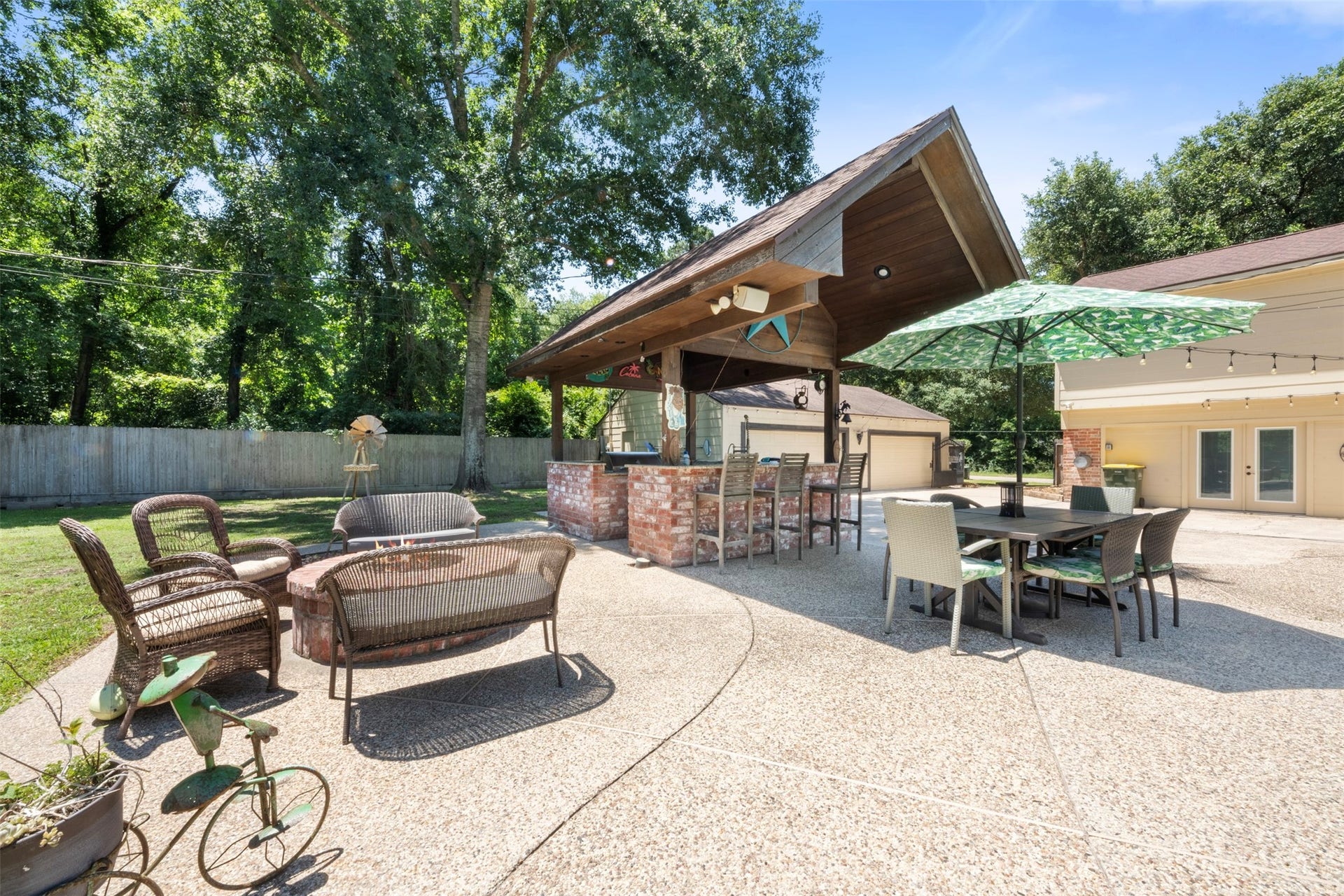 109 Riverbrook Drive, Conroe, TX 77385 Outside patio -- gazebo, fire-pit, pool, and outdoor kitchen.