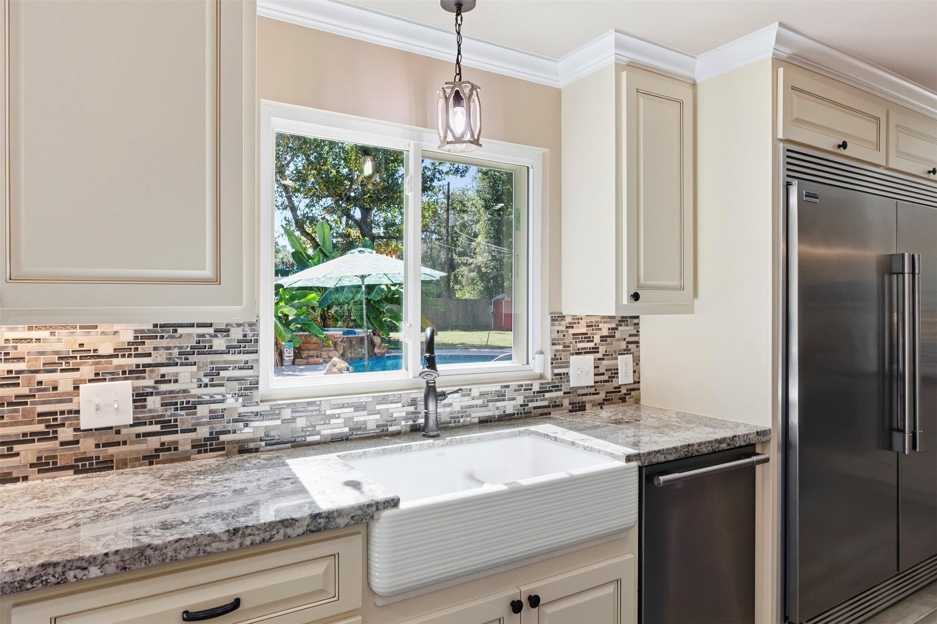 109 Riverbrook Drive, Conroe, TX 77385 Farmhouse sink with window overlooking the pool