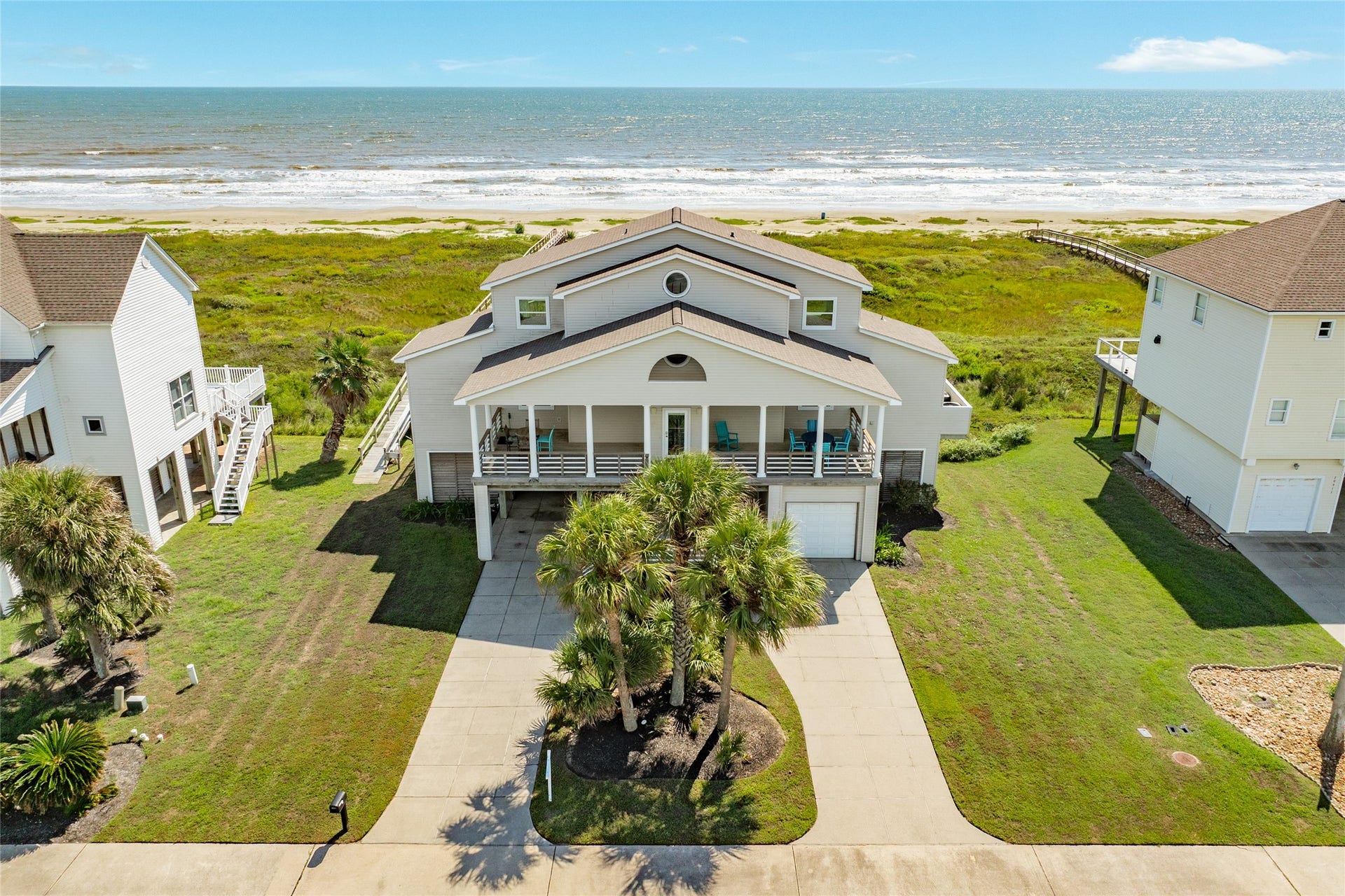 20911 W Sand Hill Drive, Galveston, TX 77554 Mature landscaping is watered with an in-ground sprinkler system
