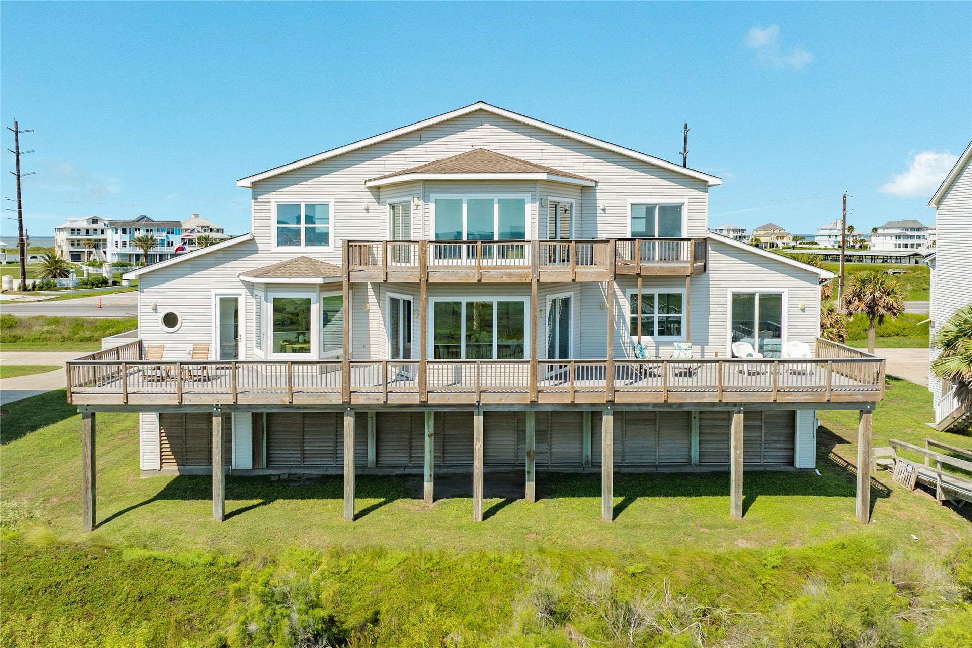 20911 W Sand Hill Drive, Galveston, TX 77554 Expansive deck across the south side of the home has open and covered areas