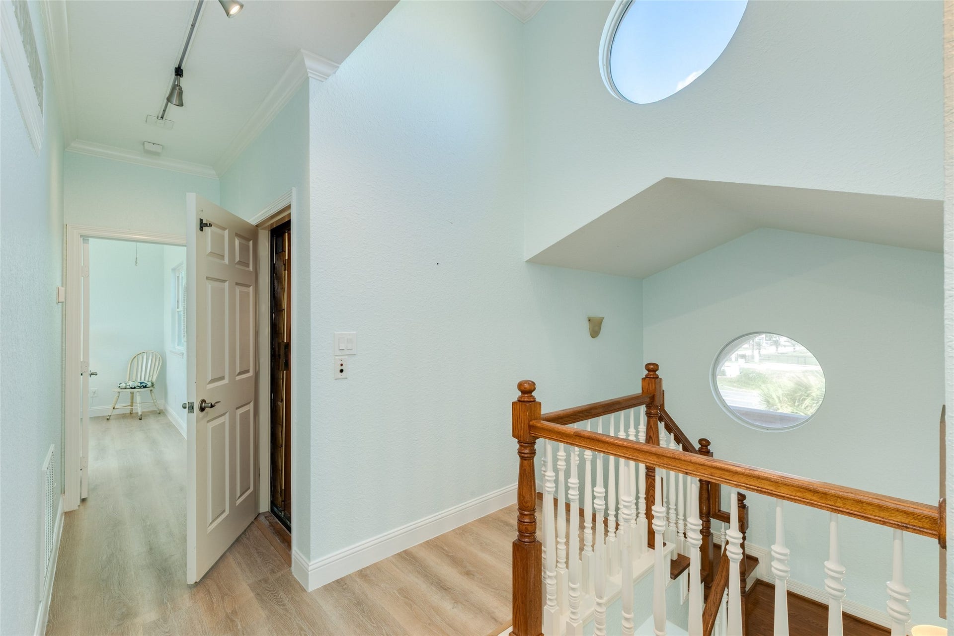 20911 W Sand Hill Drive, Galveston, TX 77554 Upstairs landing with decorative porthole windows for lots of natural light