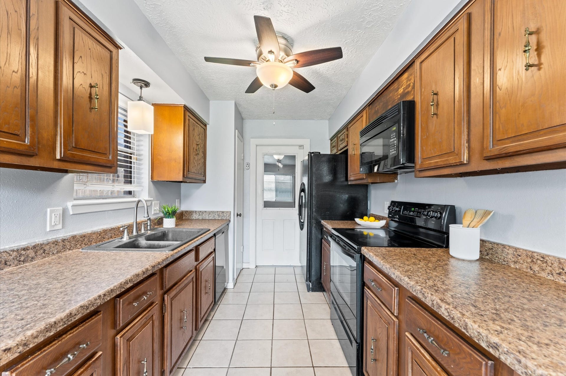 11227 Verlaine Drive, Houston, TX 77065 A traditional galley kitchen design keeps everything you need within reach, and the fridge is included!