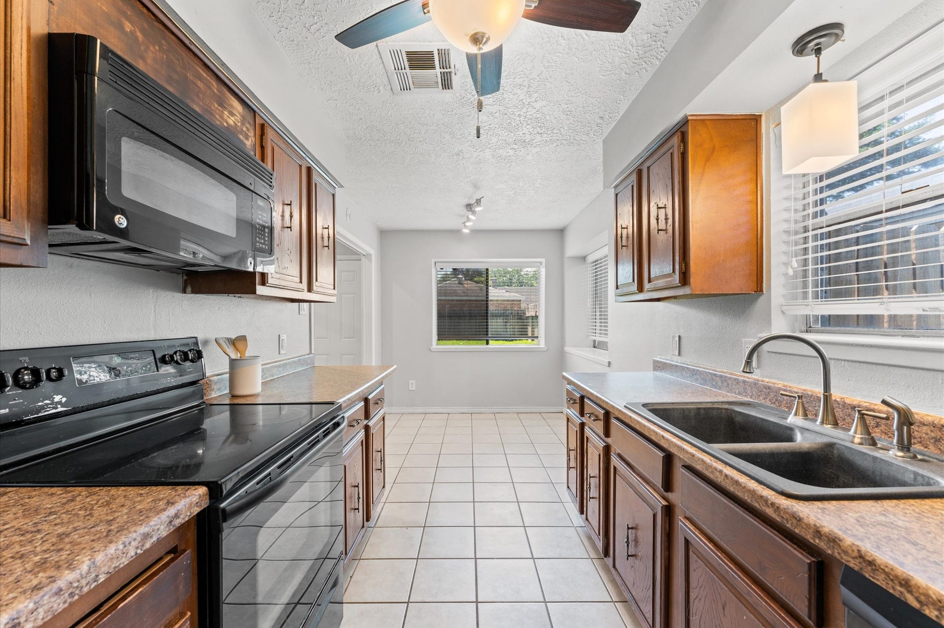 11227 Verlaine Drive, Houston, TX 77065 From the kitchen looking toward the breakfast room. Note the double sink that rests under the kitchen window.
