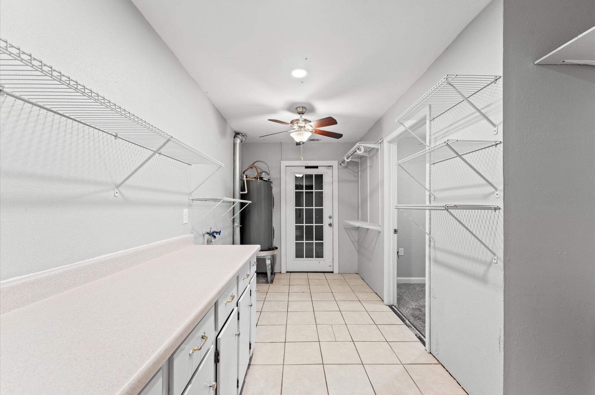 11227 Verlaine Drive, Houston, TX 77065 Near the front entry to the home is this large space that includes the laundry room, extra storage, a 2023 water heater, and access to a flex space or 4th bedroom.