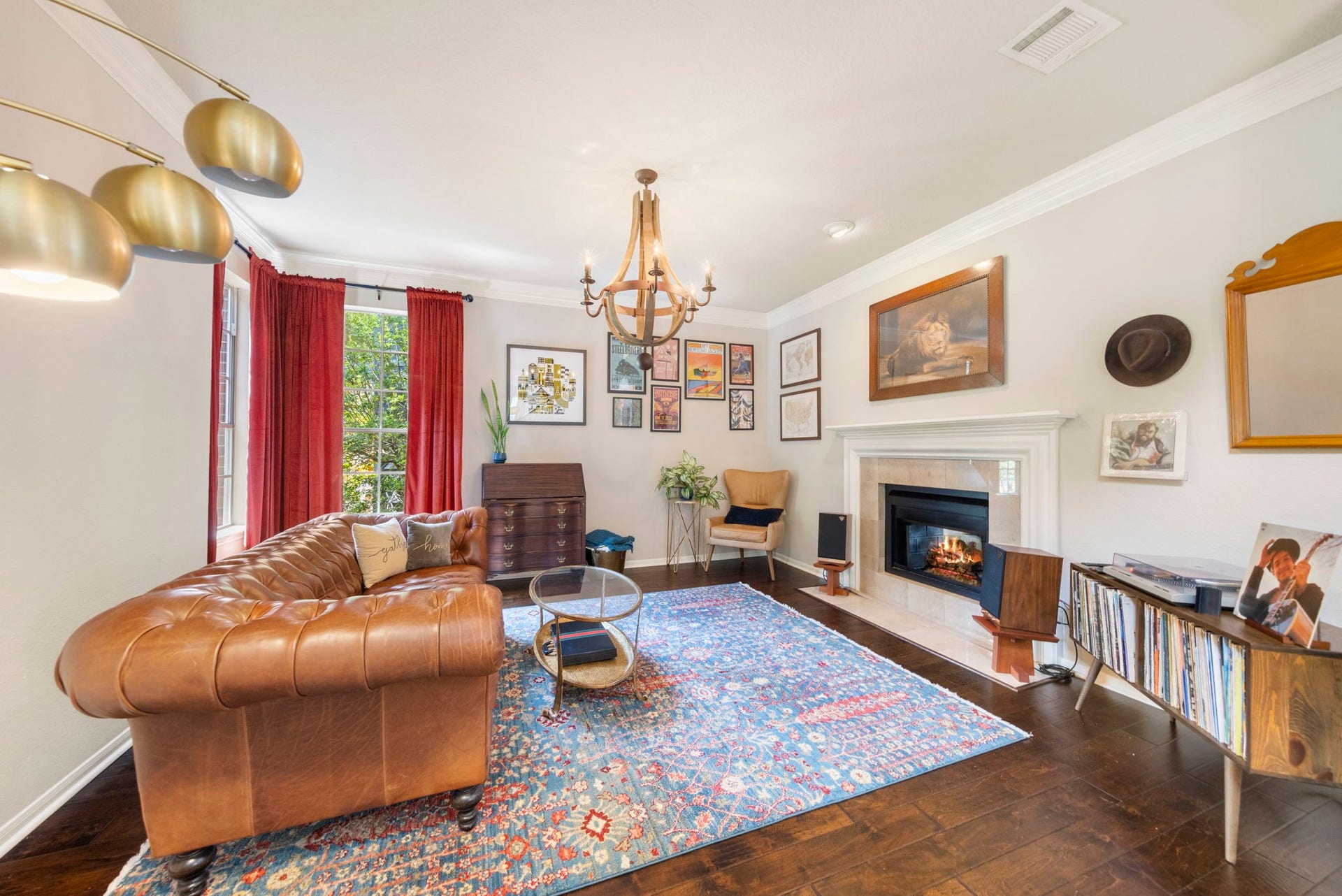 6 N Cochrans Green Circle, The Woodlands, TX 77381 Elegant formal living room anchored by a gas-log fireplace with travertine surround, classic white mantel, and crown molding.