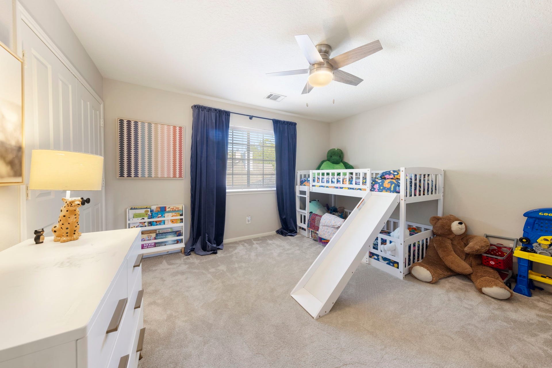 6 N Cochrans Green Circle, The Woodlands, TX 77381 Generously sized bedroom with plush carpet, a full wall of closet space, and cheerful natural light.