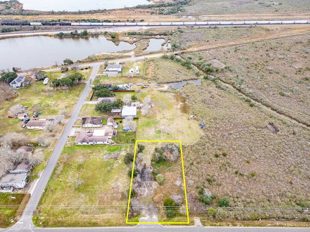 4811 Highway 6, Hitchcock, TX 77563 Elevated aerial view highlighting the subject property, Highway 6 frontage, surrounding development, nearby waterways, and rail corridor.