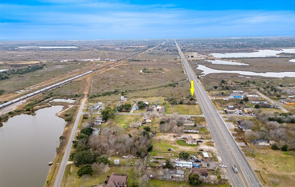 4811 Highway 6, Hitchcock, TX 77563 Long-range aerial view with arrow identifying the property and highlighting visibility along the Highway 6 corridor.