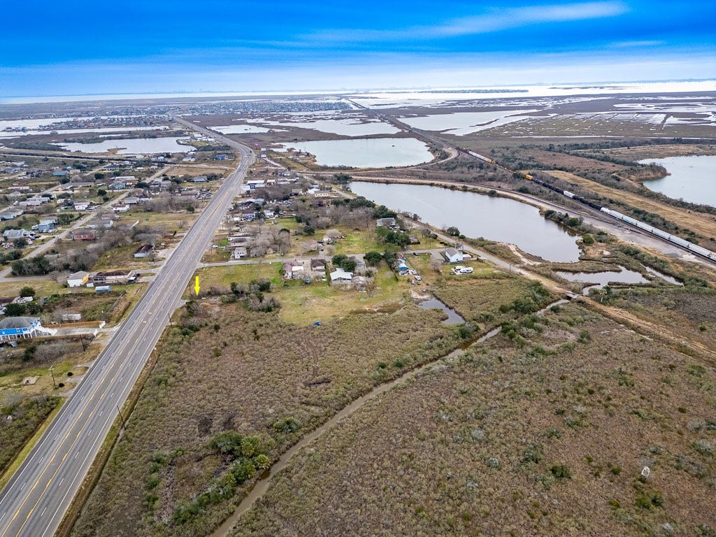 4811 Highway 6, Hitchcock, TX 77563 Wide aerial perspective with arrow identifying the subject property and showcasing its position along Highway 6.