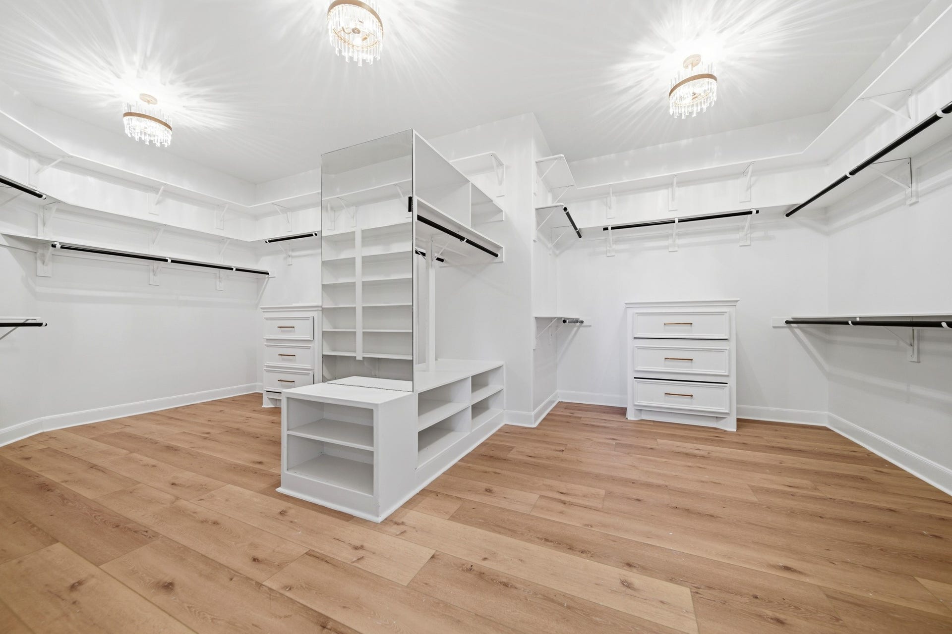 15 Bees Creek Court, Missouri City, TX 77459 Expansive custom walk-in closet with built-ins, storage island, and boutique-style organization.