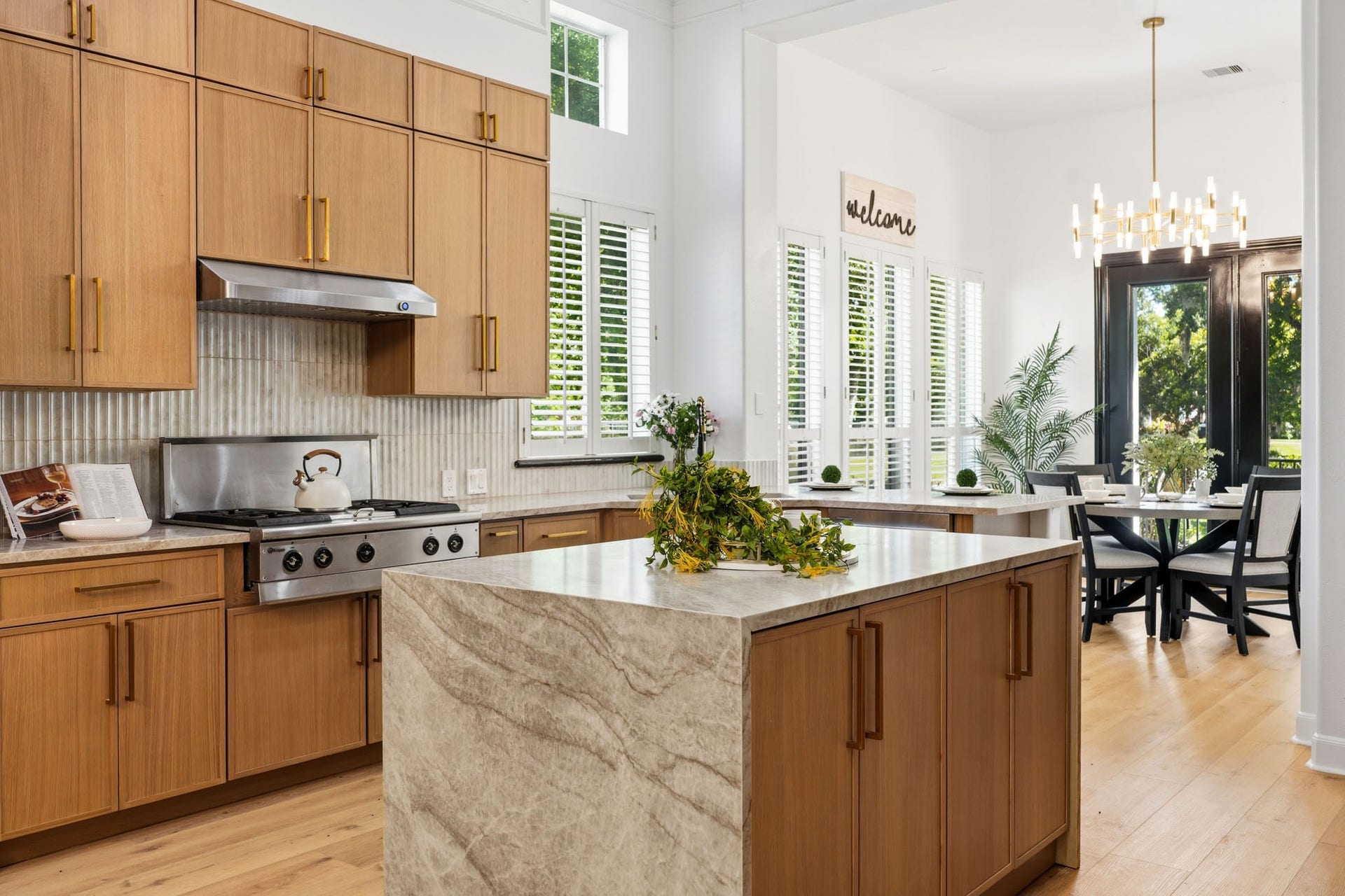 15 Bees Creek Court, Missouri City, TX 77459 Designer KITCHEN showcases a dramatic stone waterfall island, custom cabinetry, premium appliances, and extensive recent upgrades throughout.