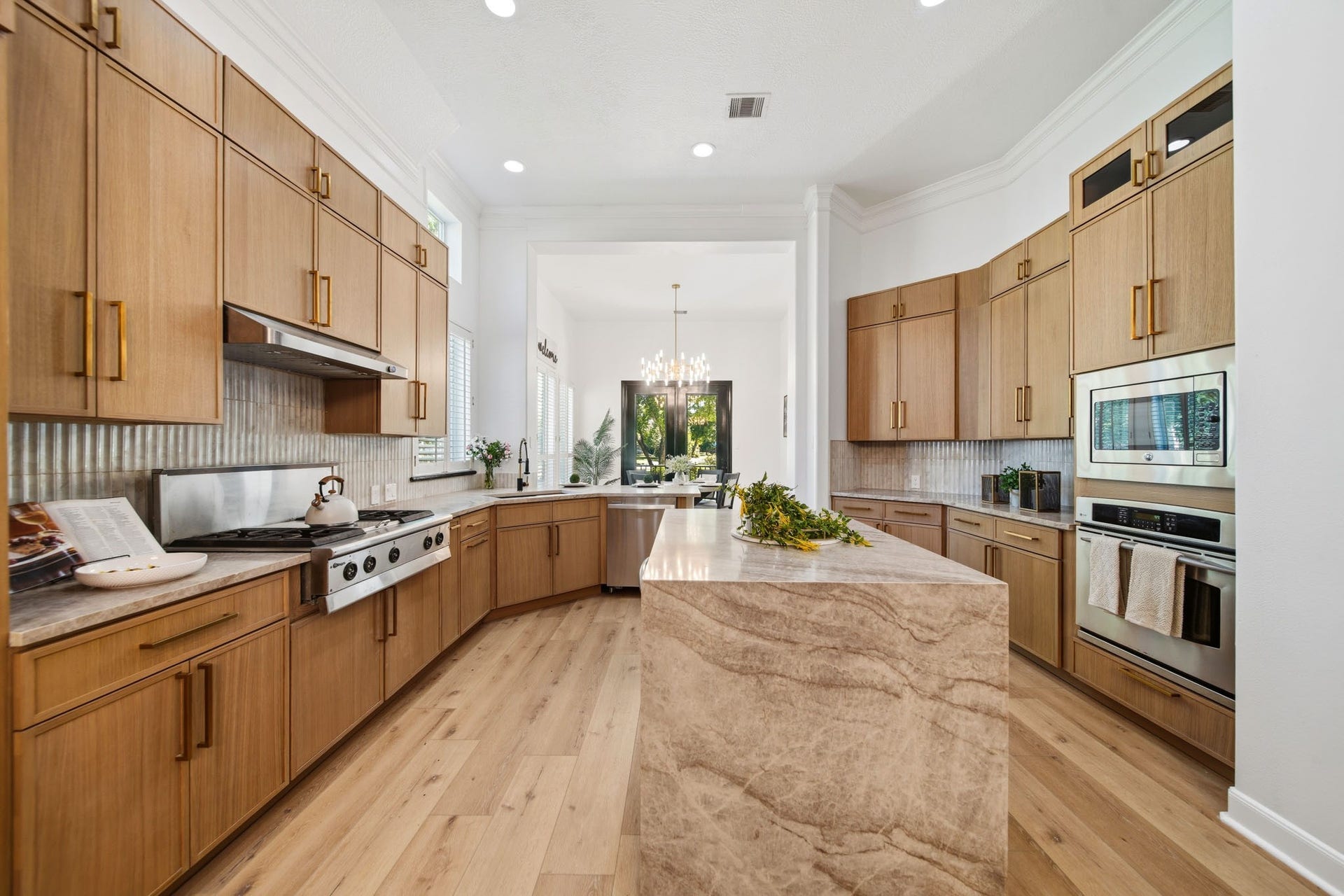 15 Bees Creek Court, Missouri City, TX 77459 Chef-inspired kitchen with custom cabinetry, premium finishes, and oversized waterfall island.