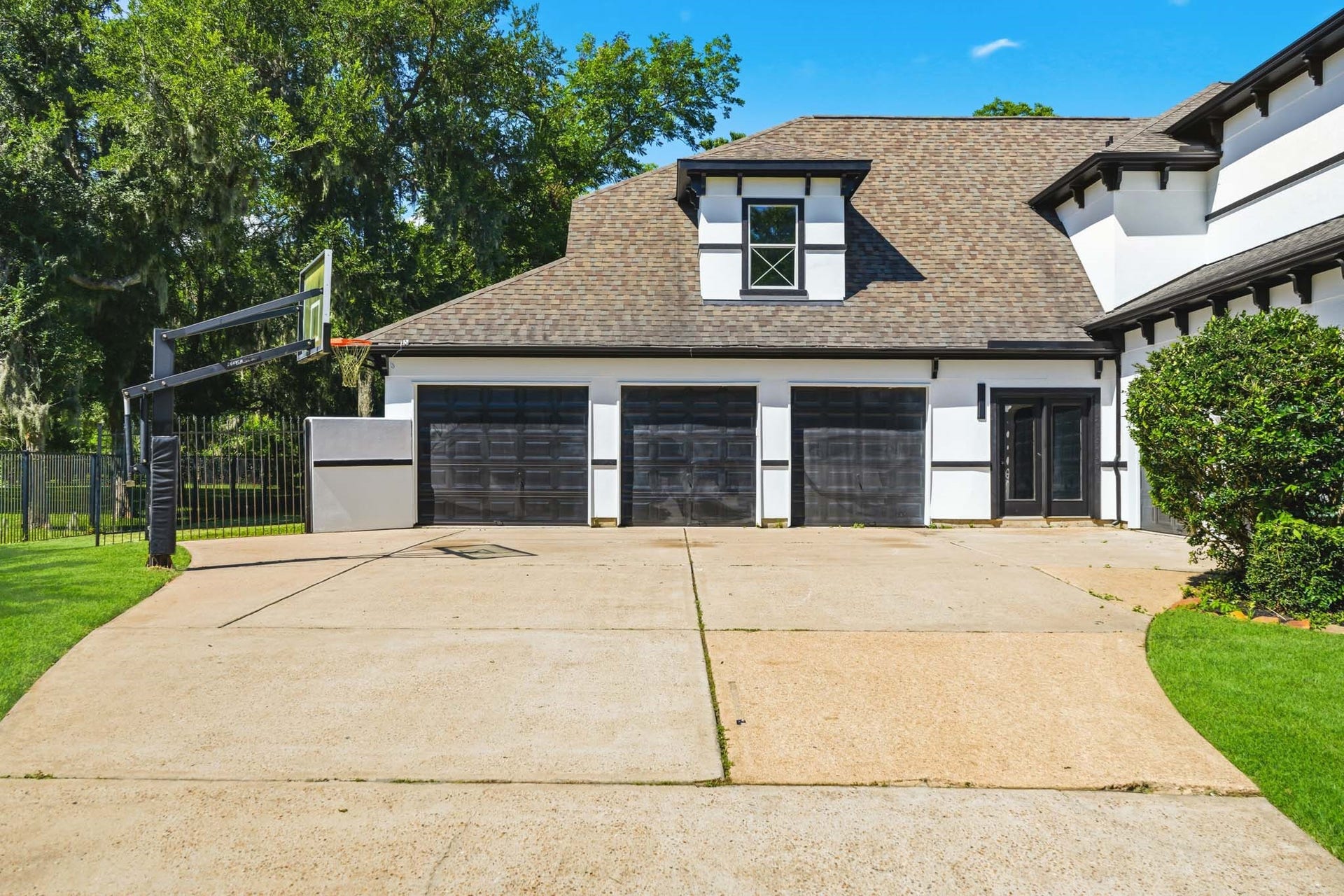 15 Bees Creek Court, Missouri City, TX 77459 Striking MODERN CUSTOM EXTERIOR with mature trees, fresh finishes, and a spacious FOUR-CAR GARAGE.