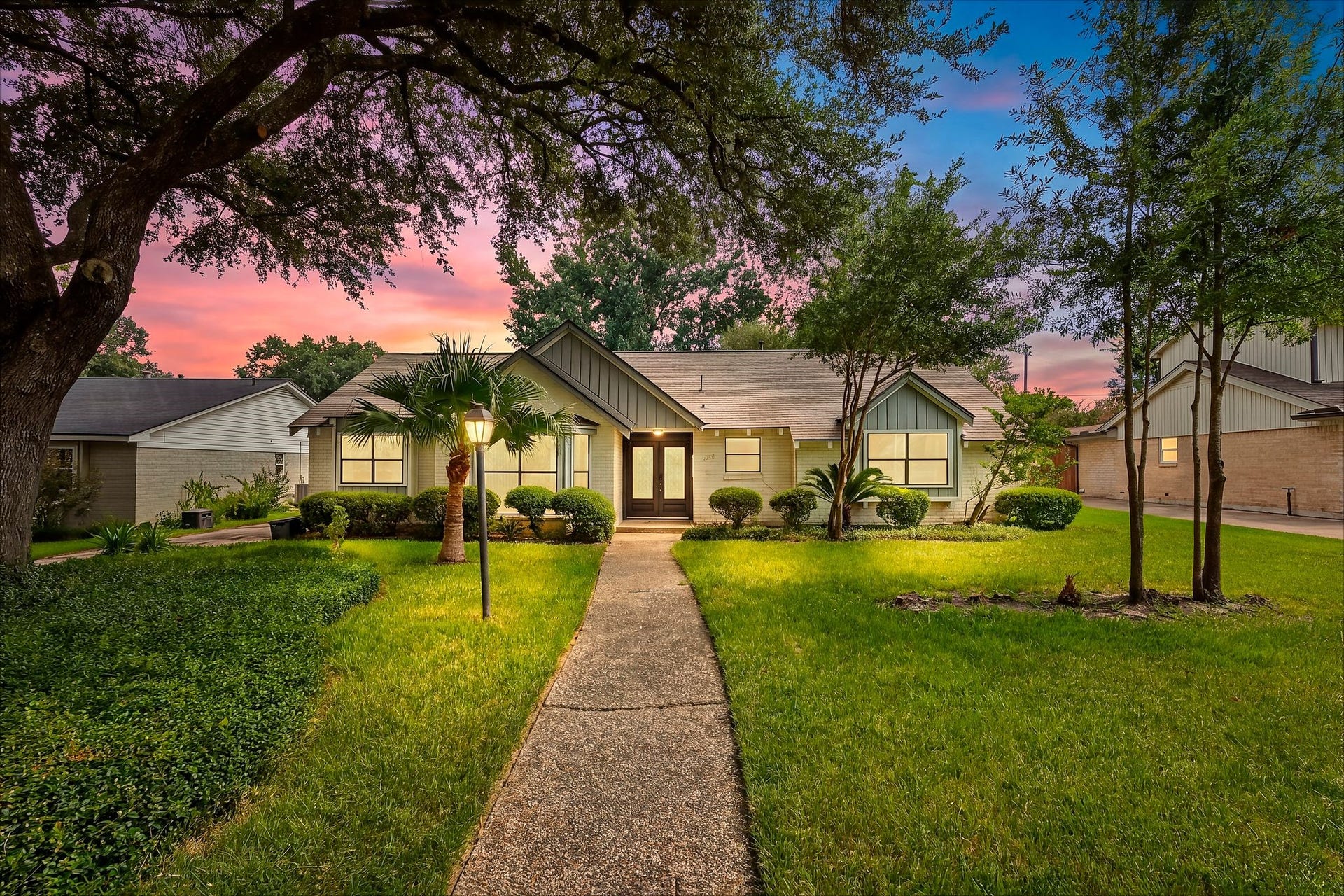 12523 Honeywood Trail, Houston, TX 77077 Front exterior with landscapeyard, mature trees, brick facade, and covered entry.