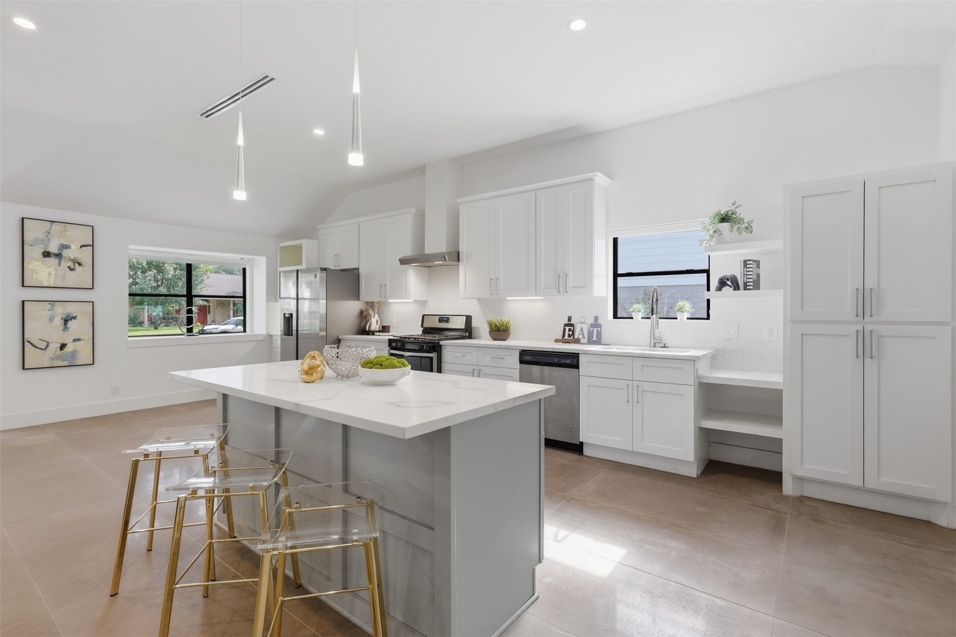 12523 Honeywood Trail, Houston, TX 77077 Modern kitchen with quartz countertops, large island, white cabinetry, stainless steel appliances, and open-concept design.