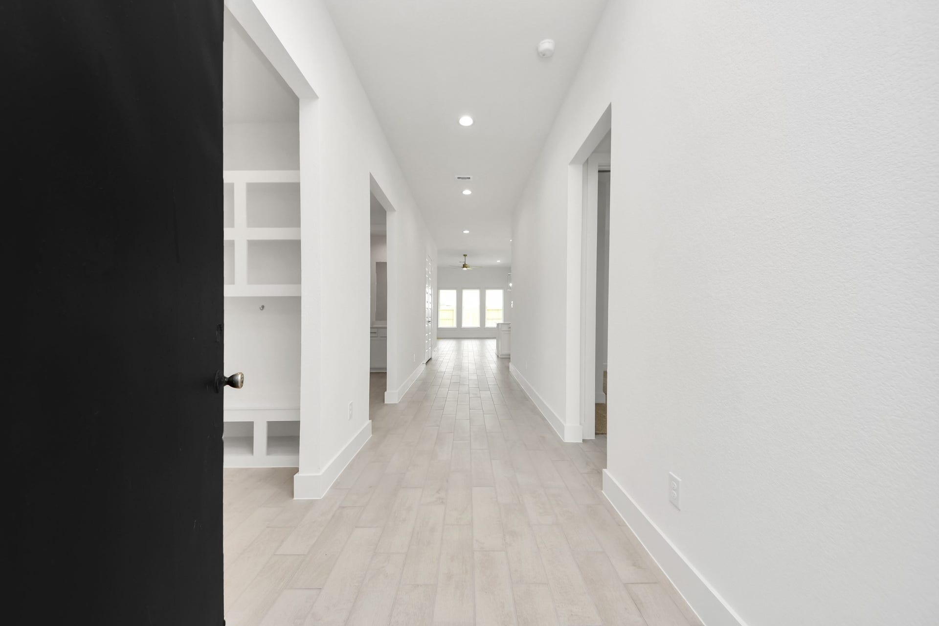 24747 Skerne Woods Drive, Spring, TX 77373 As you step into the threshold of this luxurious home, you'll soon be welcomed by an elegant glass door (to be installed). Inside, soaring ceilings amplify the spaciousness, while the refined wood-look tile flooring and oversized baseboards exude sophistication and charm. Sample photo of completed home with similar floor plan. Actual colors and selections may vary.