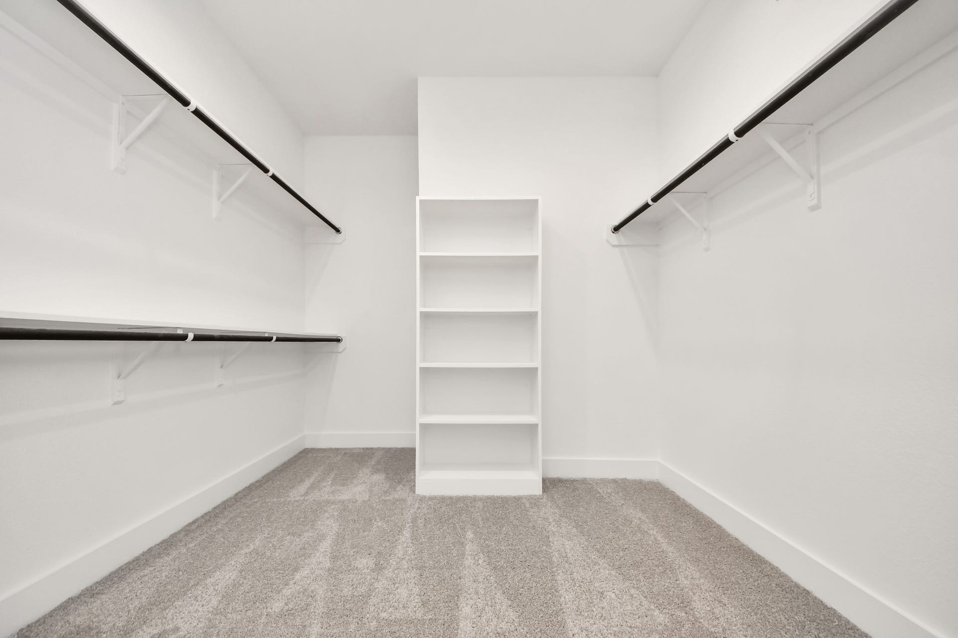 24747 Skerne Woods Drive, Spring, TX 77373 Walk-in closet that epitomizes luxury and practicality. This generously sized space features built-in shelving, offering abundant room for impeccable organization. High ceilings and recessed lighting create a bright and welcoming ambiance. Sample photo of completed home with similar floor plan. Actual colors and selections may vary.