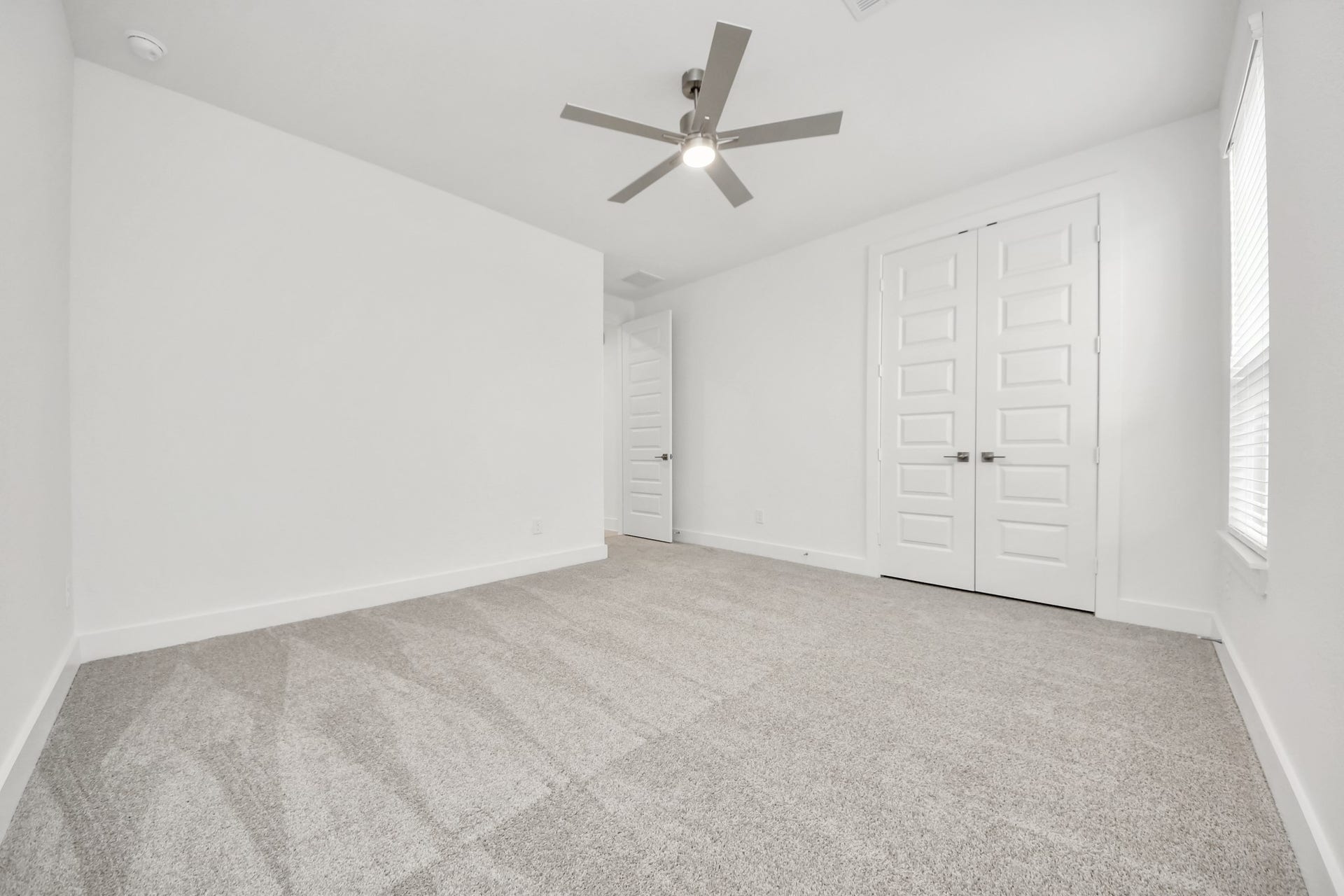 24747 Skerne Woods Drive, Spring, TX 77373 Generously sized secondary bedrooms featuring spacious closets, soft and inviting carpeting underfoot, large windows allowing plenty of natural light, and the added touch of privacy blinds for your personal retreat. Sample photo of completed home with similar floor plan. Actual colors and selections may vary.
