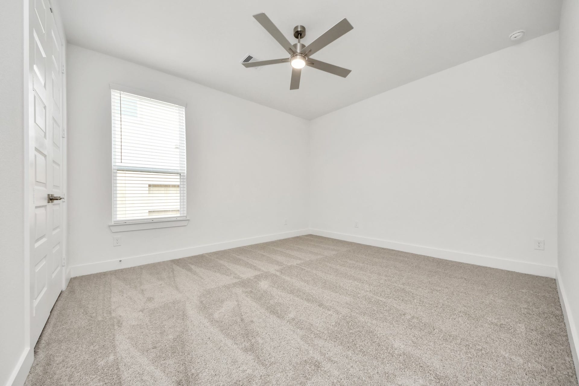 24747 Skerne Woods Drive, Spring, TX 77373 Secondary bedroom features plush carpeting, large windows that let in plenty of natural light, bright paint, and spacious closets. Sample photo of completed home with similar floor plan. Actual colors and selections may vary.