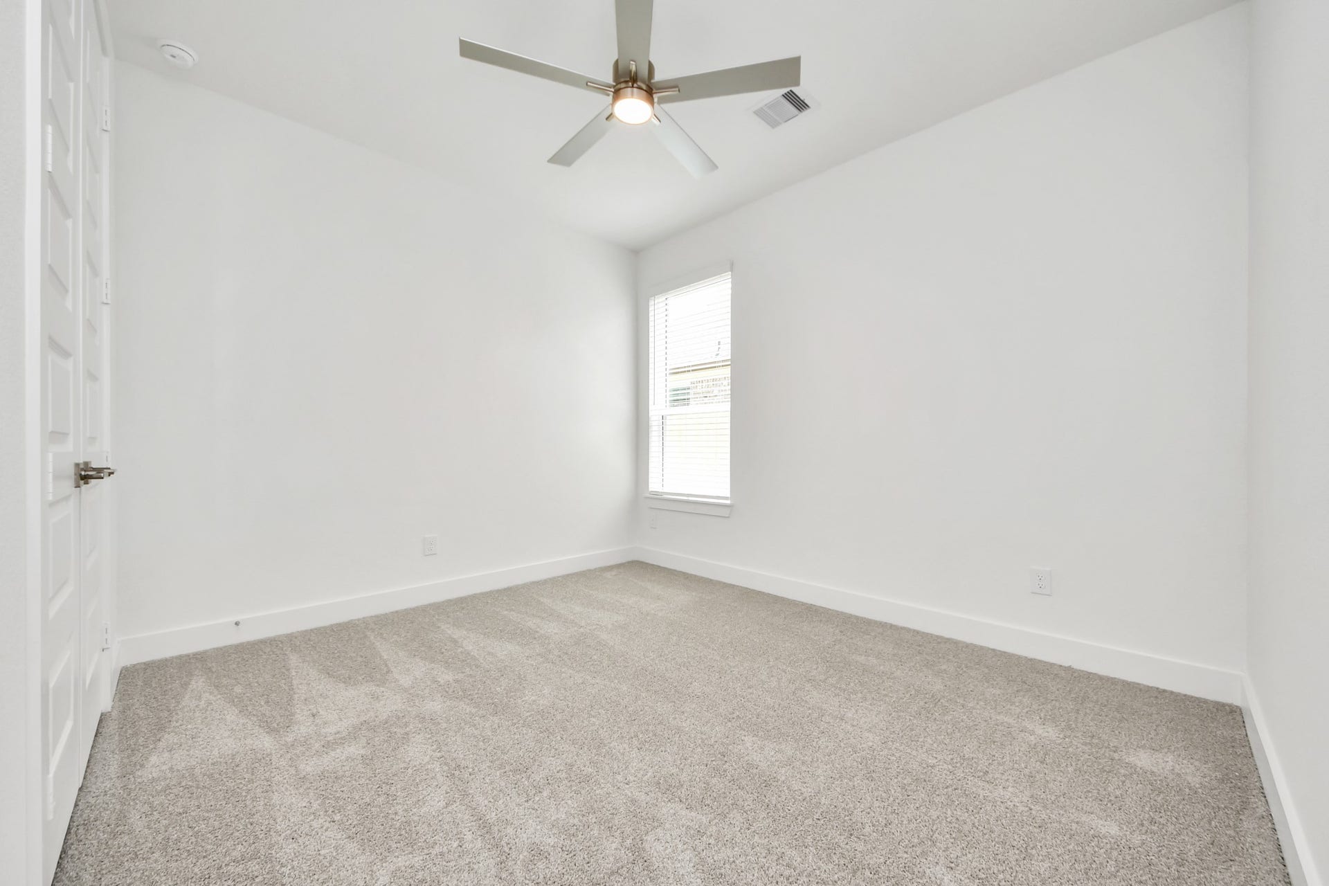 24747 Skerne Woods Drive, Spring, TX 77373 Secondary bedroom features plush carpeting, large windows that let in plenty of natural light, bright paint, and spacious closets. Sample photo of completed home with similar floor plan. Actual colors and selections may vary.