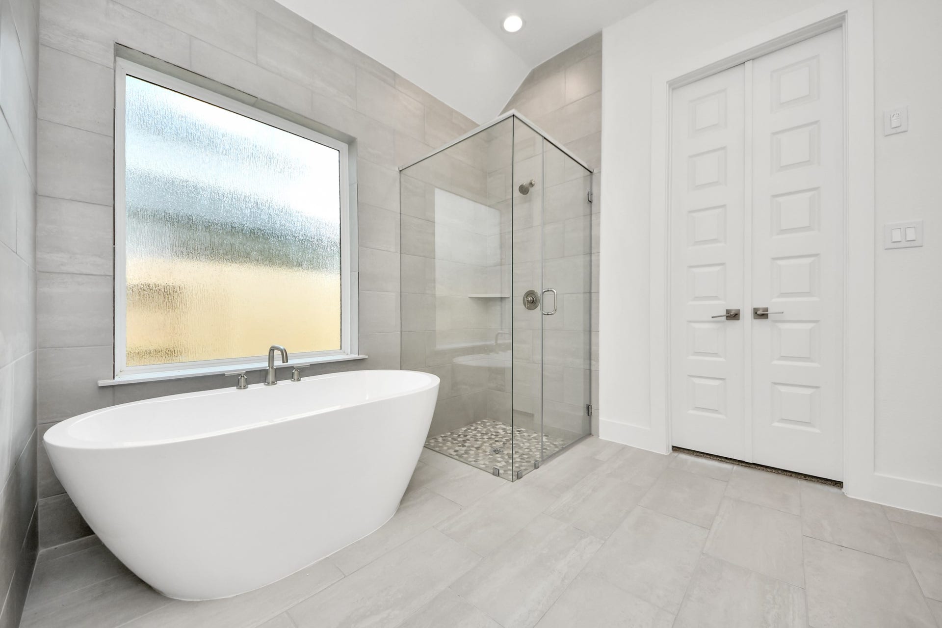 24747 Skerne Woods Drive, Spring, TX 77373 Elevate your daily routine at the elegant vanity, now equipped with double sinks, light countertops, modern hardware, and beautiful recessed lights. Sample photo of completed home with similar floor plan. Actual colors and selections may vary.