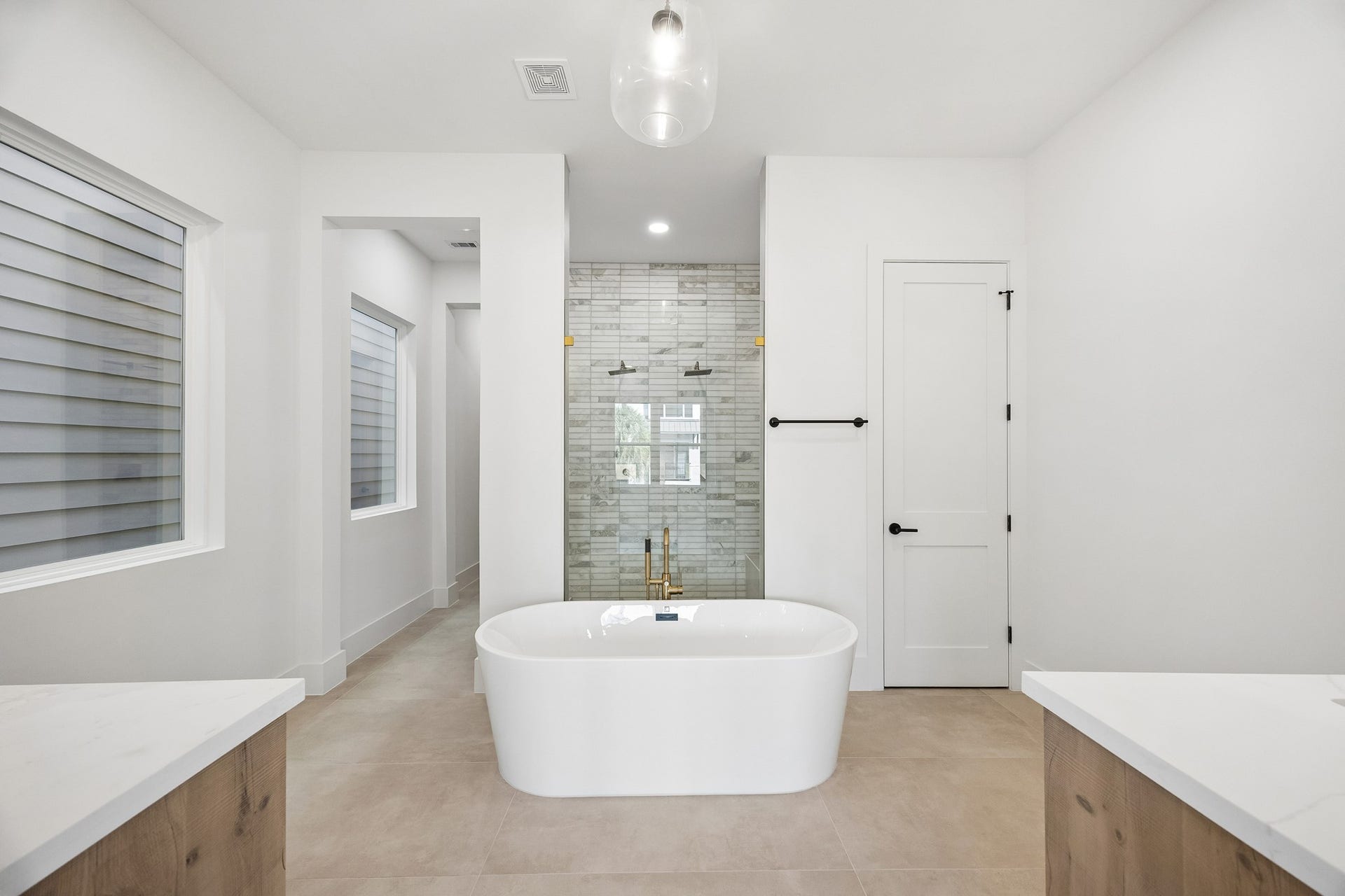 4305 Floyd Street, #B, Houston, TX 77007 Luxurious primary bath offers a wood-tone vanity, designer mirror and freestanding tub.