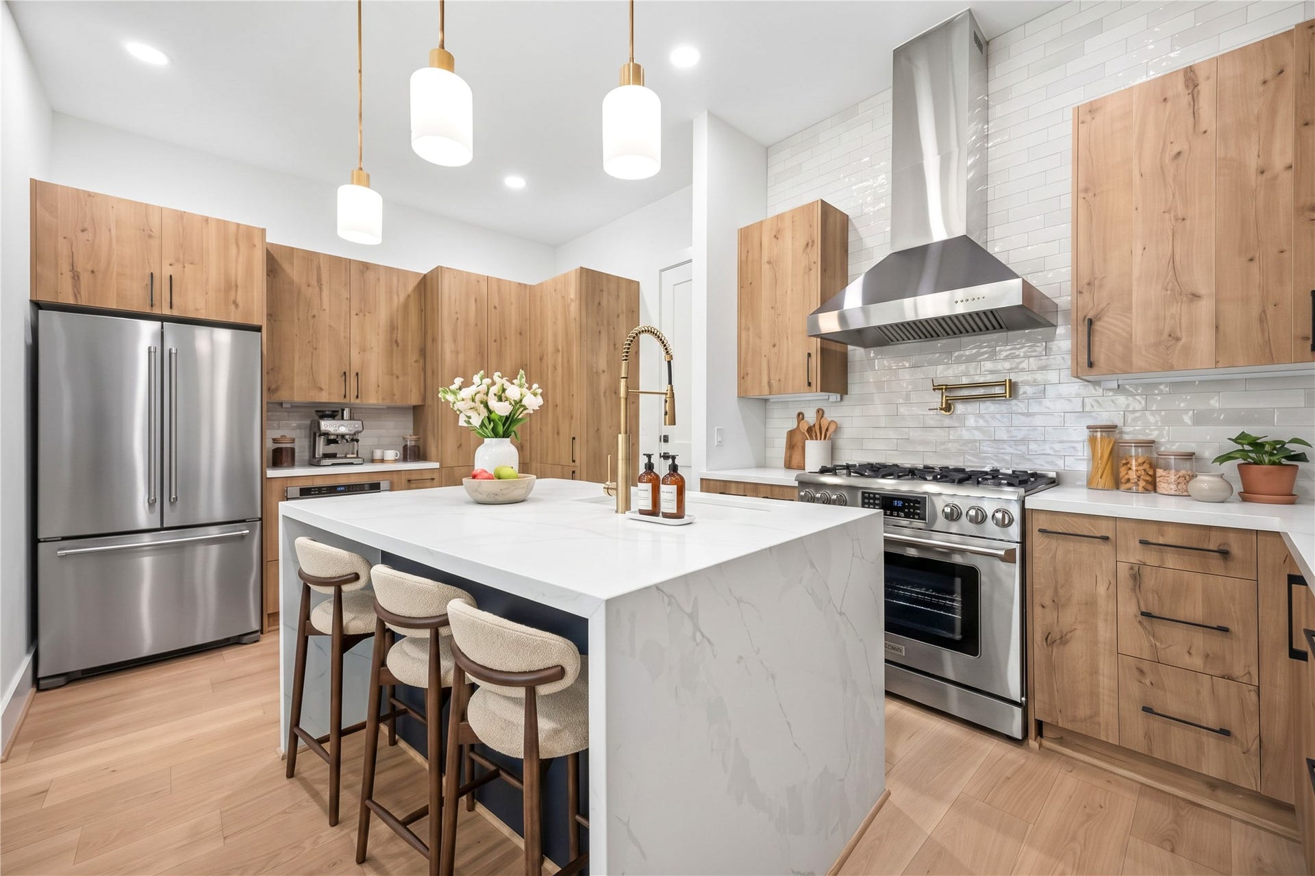 4305 Floyd Street, #B, Houston, TX 77007 Kitchen expansive waterfall island provides additional prep and seating space, complemented by a stainless steel gas range and pot filler. (virtual staging)