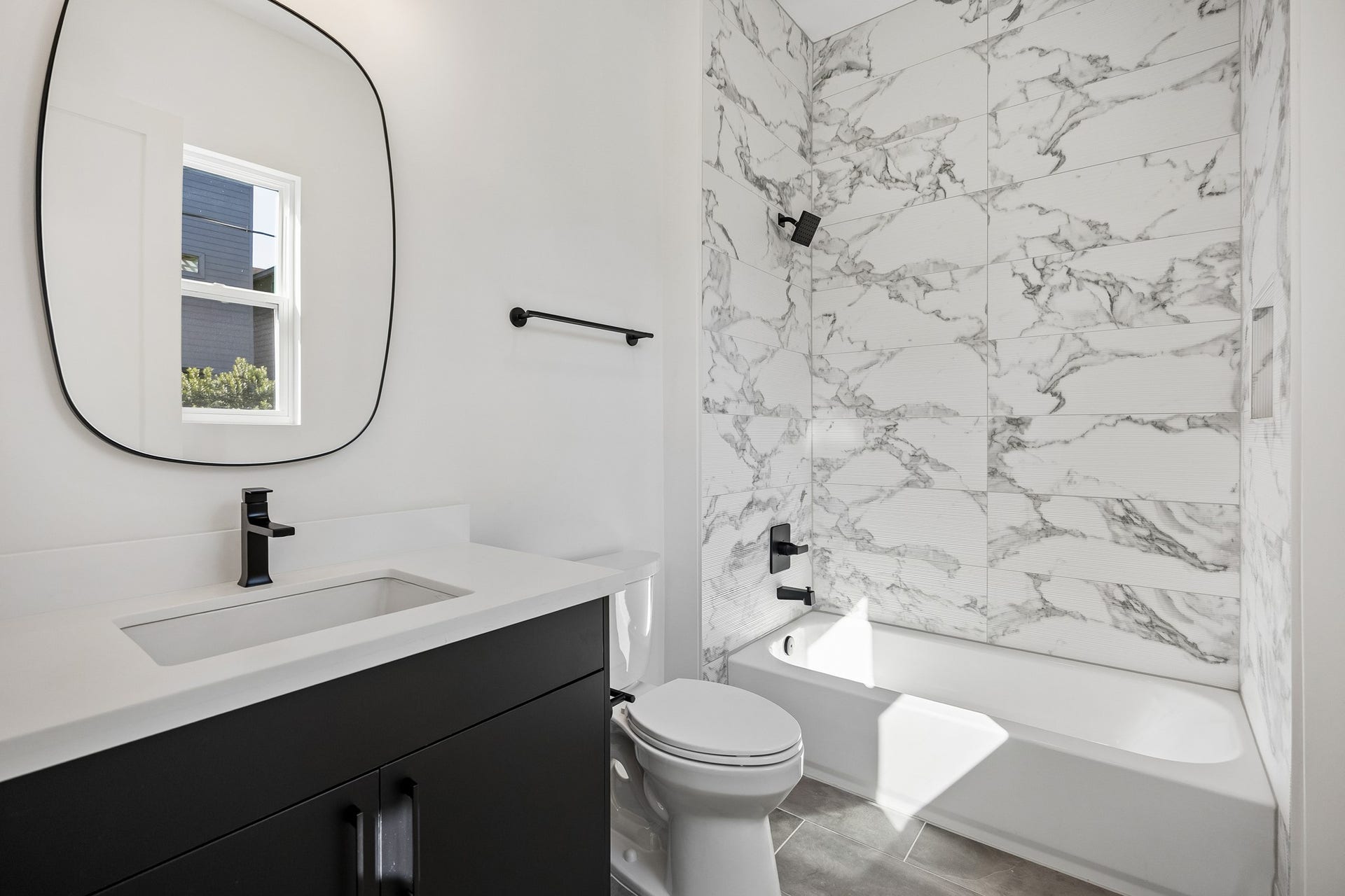 4305 Floyd Street, #B, Houston, TX 77007 Bath #3 offers a dark vanity, designer mirror and tub/shower combo.