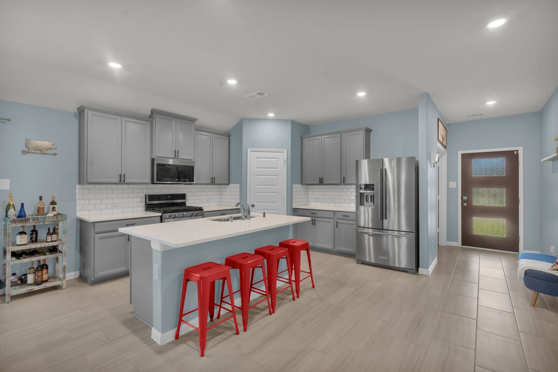 2315 Scarlett Pine Bend, Tomball, TX 77375 Stunning kitchen features gorgeous cabinetry, a massive center island with breakfast bar seating, stainless steel appliances, and an oversized walk-in pantry. Refrigerator is included.