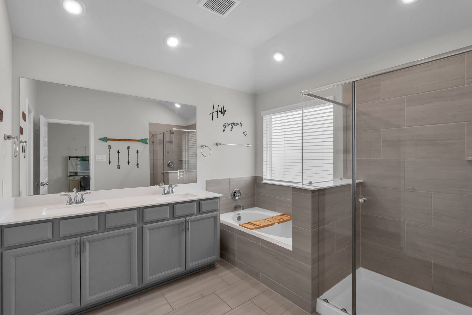 2315 Scarlett Pine Bend, Tomball, TX 77375 Primary bathroom features dual sinks, a relaxing soaking tub, and a glass-standing shower.
