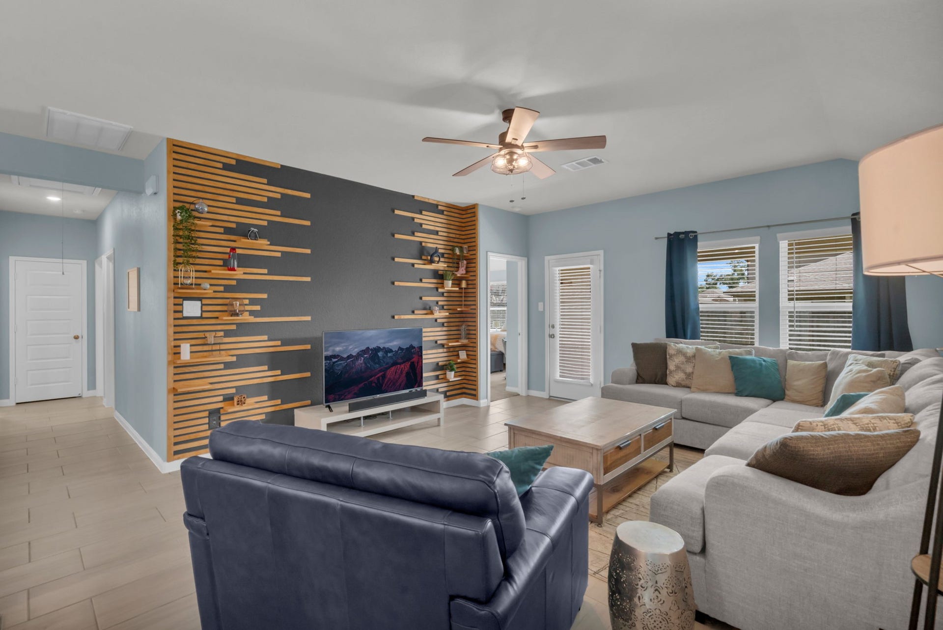 2315 Scarlett Pine Bend, Tomball, TX 77375 Impressive living room features striking custom built-in shelving and beautiful views of the backyard.