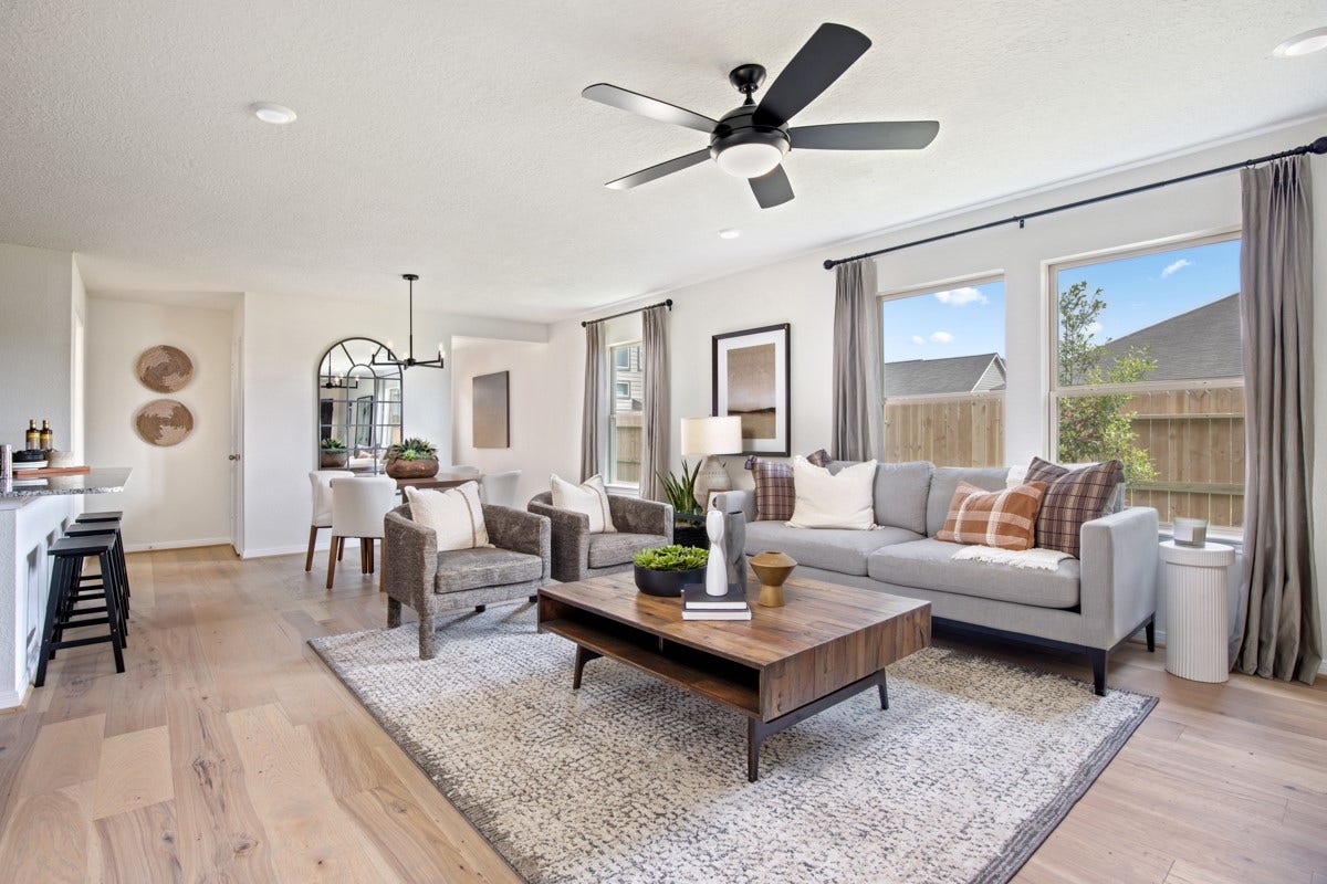 This bright and airy Great Room offers a spacious layout ideal for both relaxing evenings and lively gatherings. Designed for comfort and connection, it features engineered wood flooring, large windows, high ceilings, ceiling fan, recessed lighting, and seamless access to the stunning kitchenperfect for everyday living and entertaining alike.