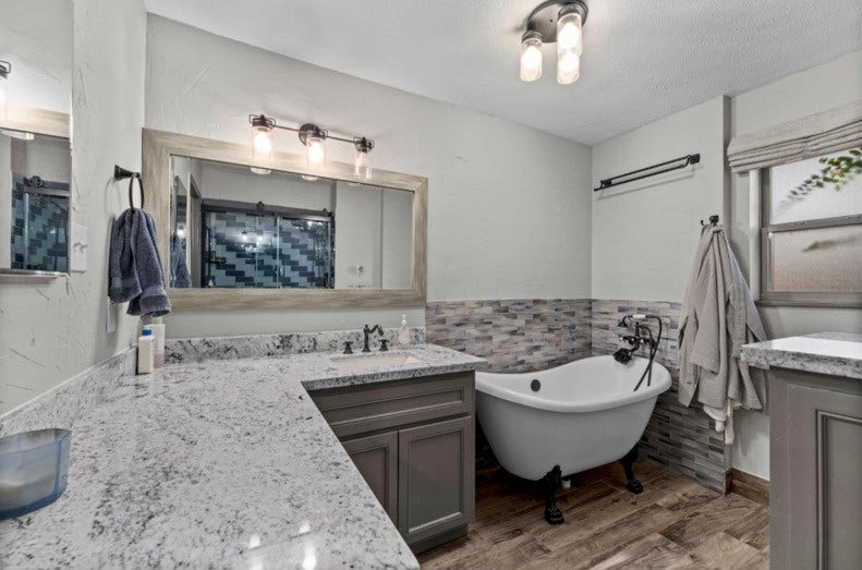 12710 Mutiny Lane, Tomball, TX 77377 Main-house bathroom with generous vanity space and a freestanding bathtub.