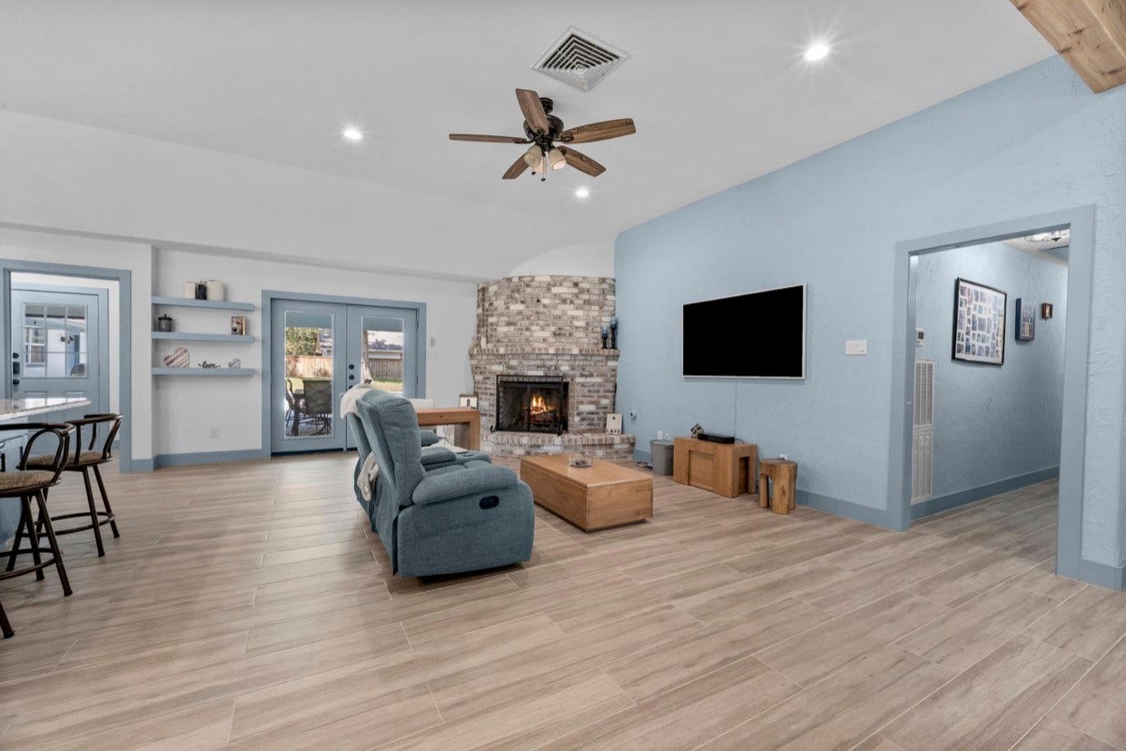 12710 Mutiny Lane, Tomball, TX 77377 Welcoming living room with a distinctive fireplace, recessed lighting, and a ceiling fan.