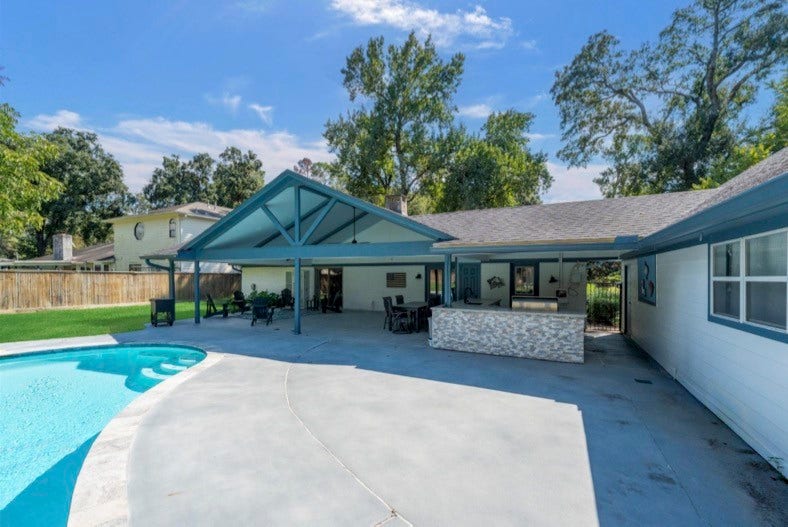 12710 Mutiny Lane, Tomball, TX 77377 Poolside view of the covered patio and outdoor kitchen.
