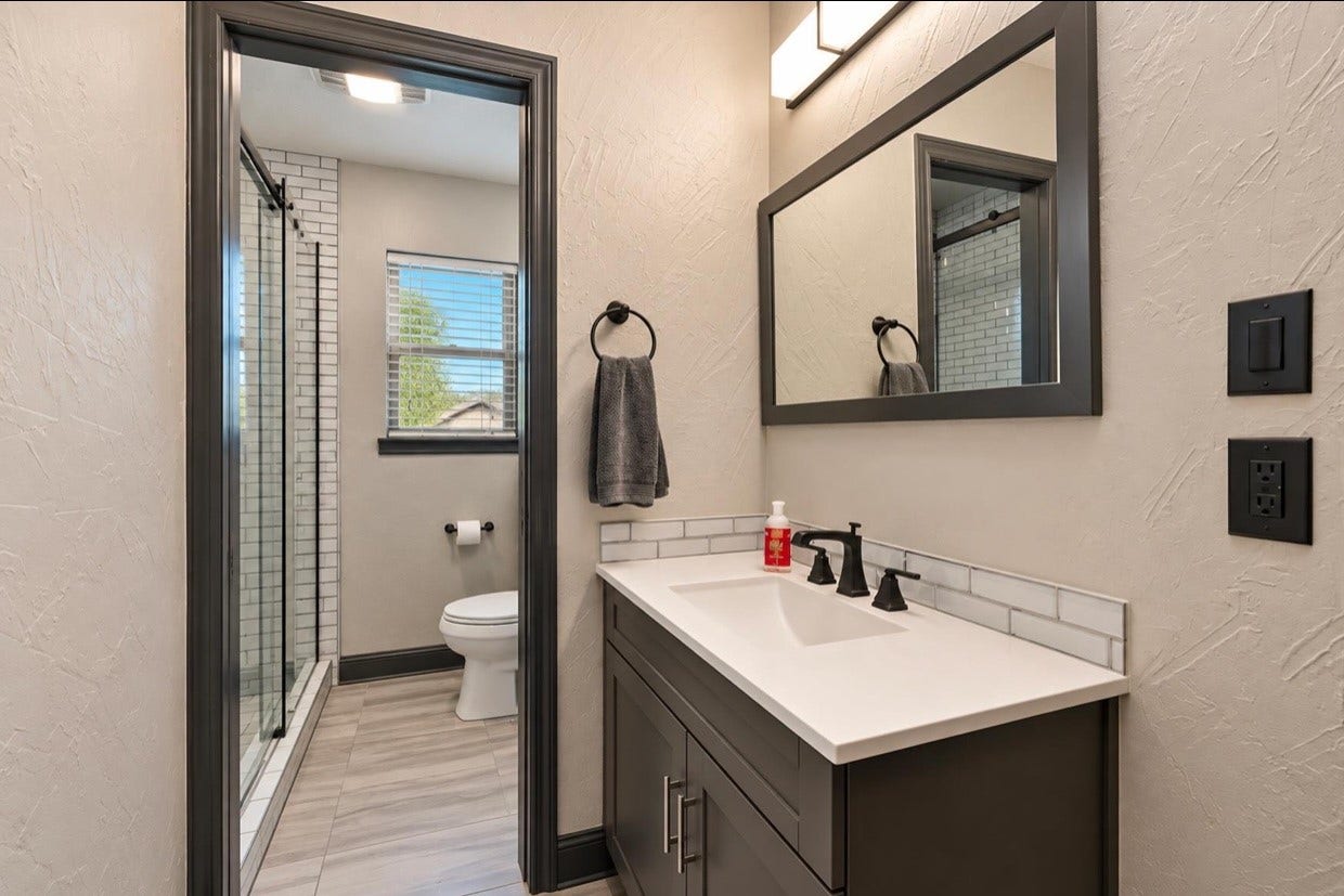 12710 Mutiny Lane, Tomball, TX 77377 View through the guest-suite bathroom from the vanity toward the shower area.