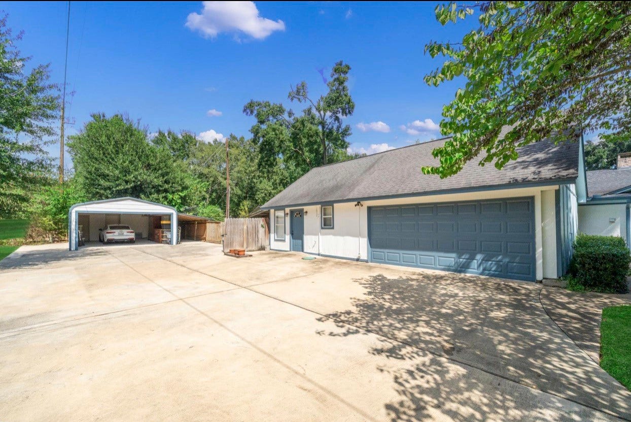 12710 Mutiny Lane, Tomball, TX 77377 Wide driveway with access to the garage and covered parking area.