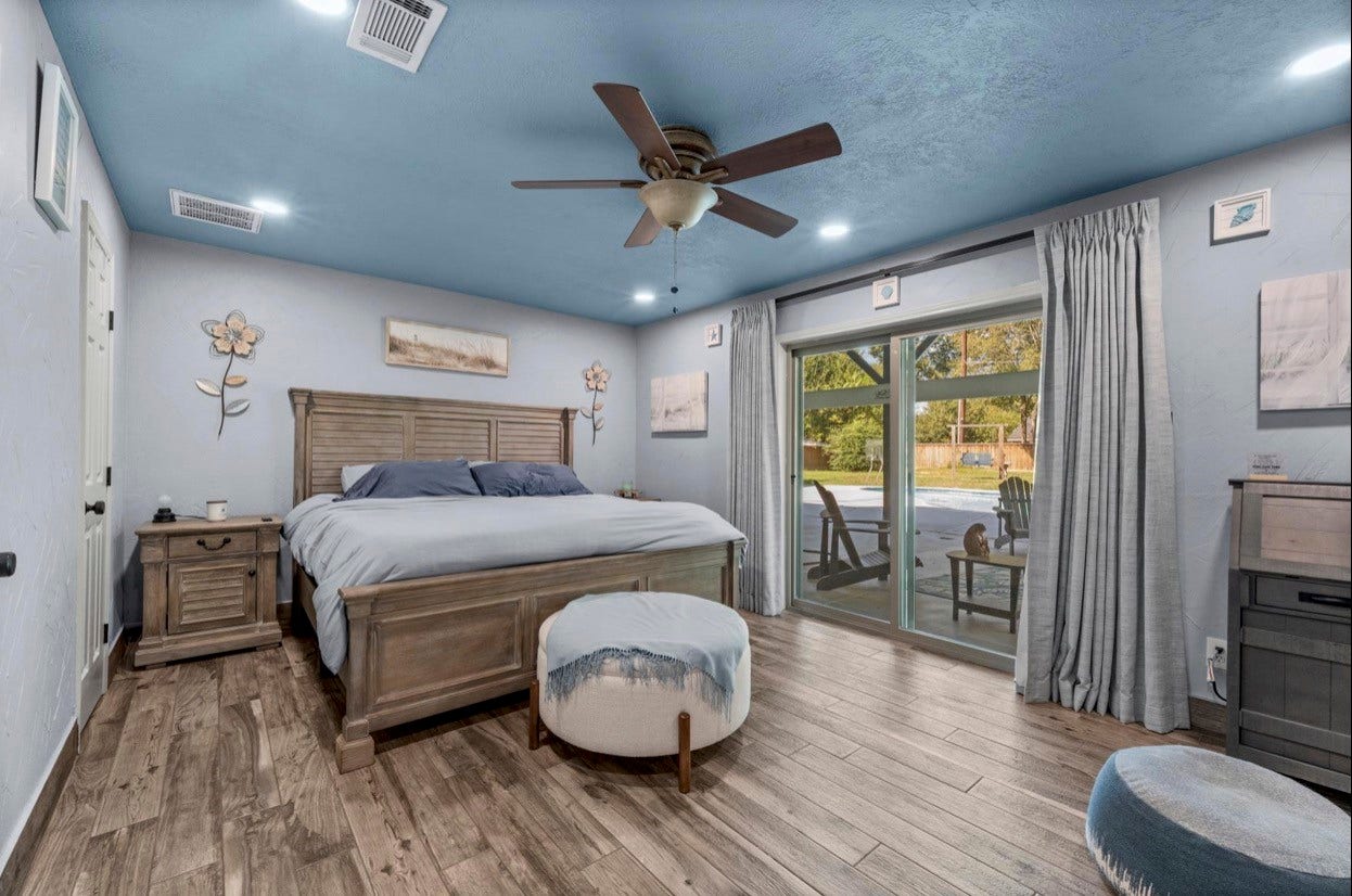 12710 Mutiny Lane, Tomball, TX 77377 Primary bedroom with a blue accent ceiling, ceiling fan, and glass doors opening toward the patio.