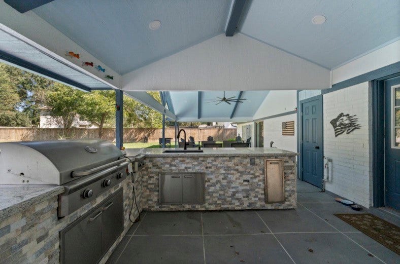 12710 Mutiny Lane, Tomball, TX 77377 Outdoor kitchen with a built-in grill, sink, counter space, and storage.
