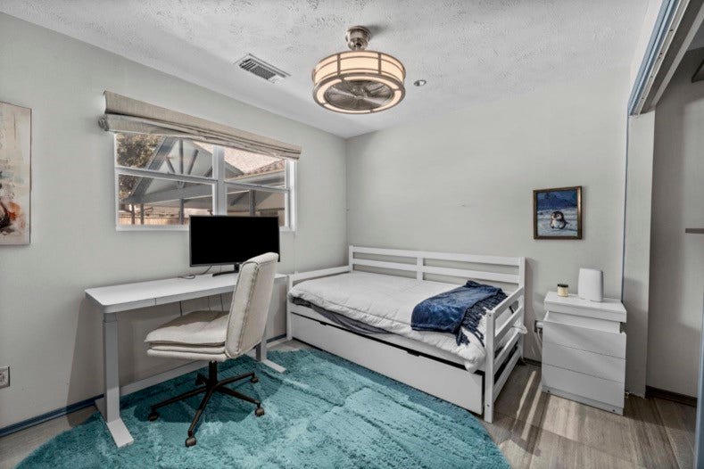 12710 Mutiny Lane, Tomball, TX 77377 Separate guest-suite bedroom with natural light, closet space, and room for a desk. The suite also includes its own full kitchen, bathroom, and living/dining area.