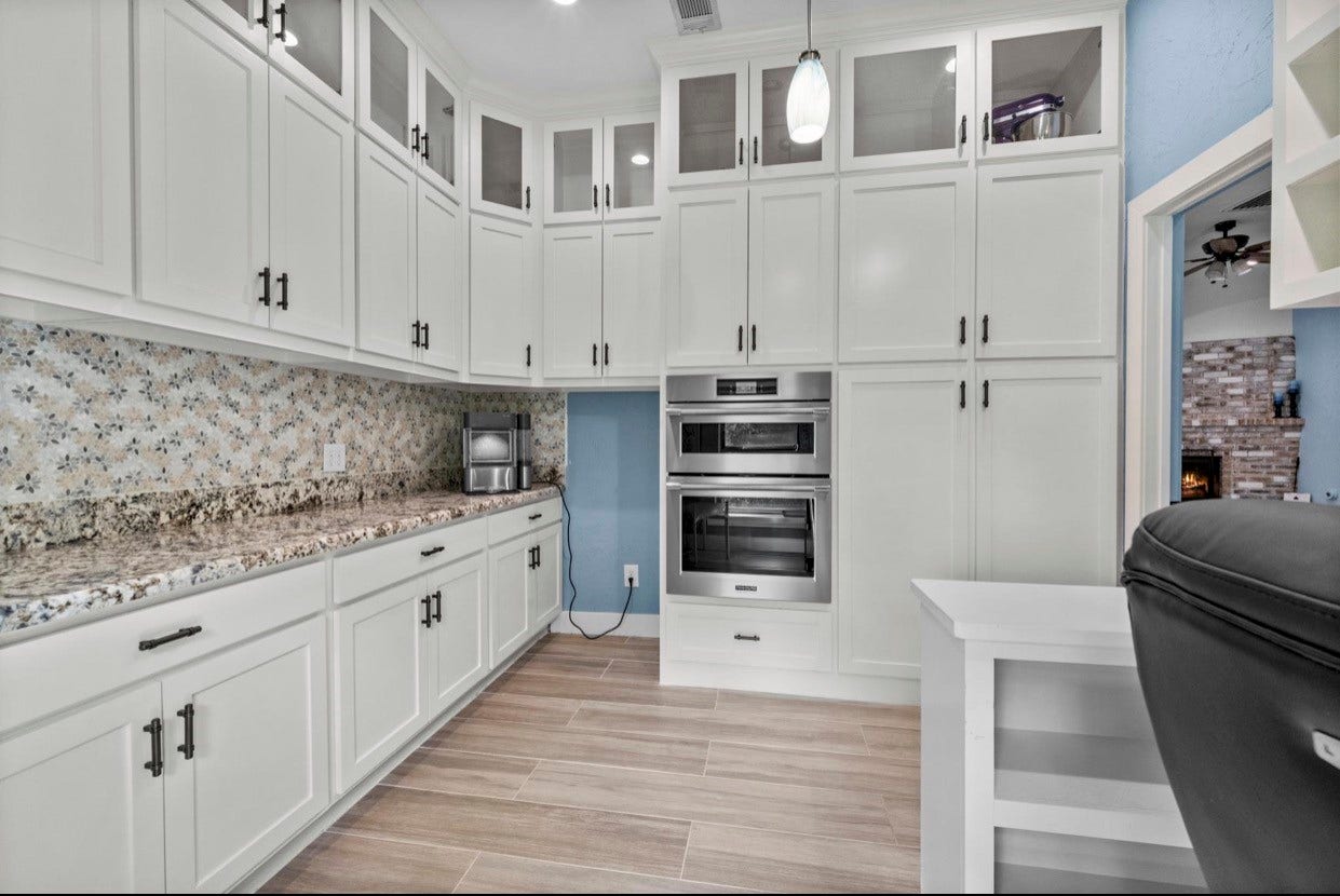 12710 Mutiny Lane, Tomball, TX 77377 Additional cabinetry and built-in appliances provide convenient storage and preparation space.